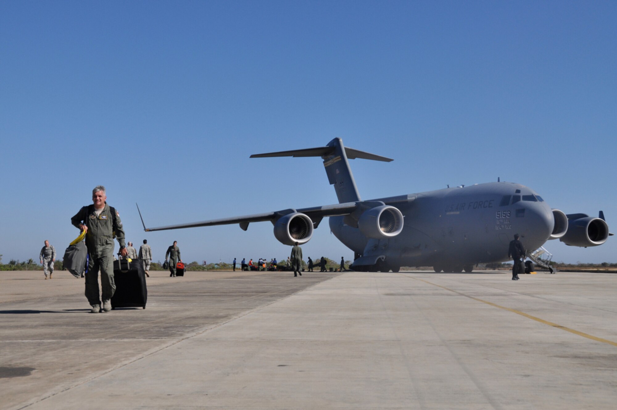 Airmen from various bases across the total force community unload their equipment and supplies from a C-17 Globemaster III after landing in Kupang, Indonesia, July 15 to support Operation Pacific Angel 2009. An aircrew from the Hawaii Air National Guard?s 204th Airlift Squadron at Hickam Air Force Base, Hawaii, delivered the people and equipment for the operation. Pacific Angel is a Pacific Air Forces humanitarian assistance operation in the Asia-Pacific region led by 13th Air Force at Hickam AFB. (U.S. Air Force photo/Tech. Sgt. Cohen A. Young)