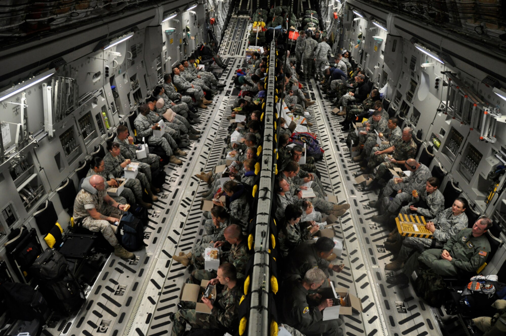 Medical and engineering personnel from various bases across the U.S. Air Force total force community get some rest aboard a C-17 Globemaster III en route to Kupang, Indonesia, July 15 in support of Operation Pacific Angel 2009.  An aircrew from the Hawaii Air National Guard?s 204th Airlift Squadron at Hickam Air Force Base, Hawaii, delivered the people and equipment for the operation. Pacific Angel is a Pacific Air Forces humanitarian assistance operation in the Asia-Pacific region led by 13th Air Force at Hickam AFB. (U.S. Air Force photo/Tech. Sgt. Cohen A. Young)
