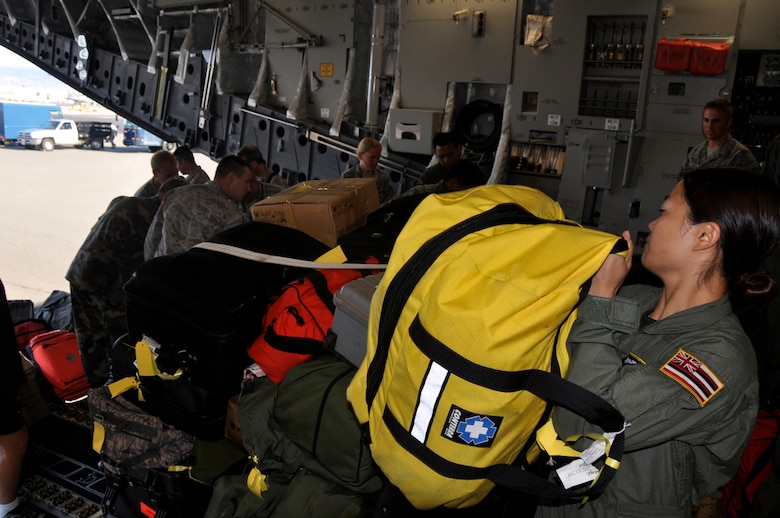 Tech. Sgt. Kimberly Kido prepares to strap down some medical bags on a C-17 Globemaster III at Hickam Air Force Base, Hawaii, before departing for Kupang, Indonesia, July 14 to support Operation Pacific Angel 2009. Sergeant Kido is a loadmaster with the Hawaii Air National Guard?s 204th Airlift Squadron at Hickam. Pacific Angel is a Pacific Air Forces humanitarian assistance operation in the Asia-Pacific region led by 13th Air Force at Hickam AFB. (U.S. Air Force photo/Tech. Sgt. Cohen A. Young)