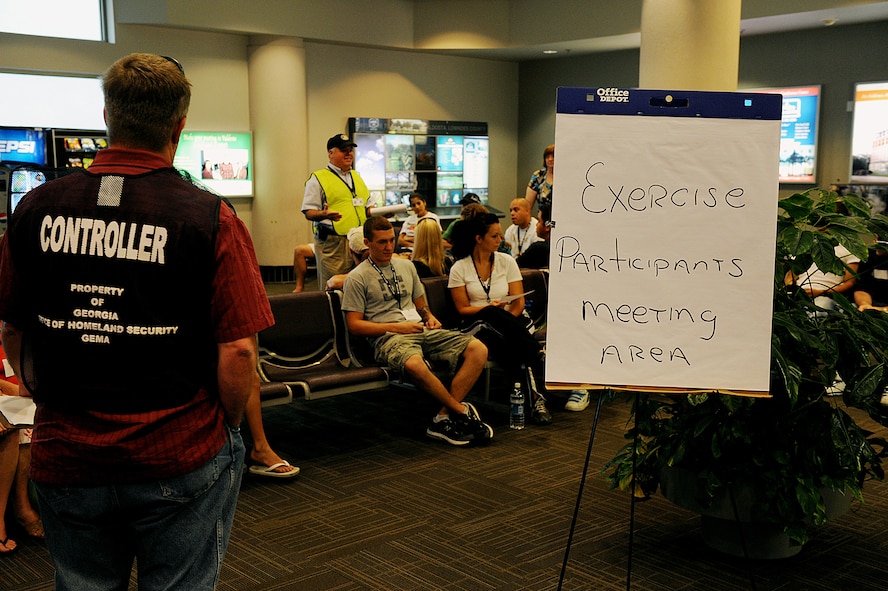 MOODY AIR FORCE BASE, Ga. – Volunteers receive a safety briefing before the start of an emergency response exercise at the Valdosta Regional Airport July 18. This is an annual exercise coordinated by Homeland Security members, the airport, Lowndes County Police Department and Moody's 23rd Civil Engineer Squadron Emergency Management Flight. (U.S. Air Force photo by Airman 1st Class Joshua Green)