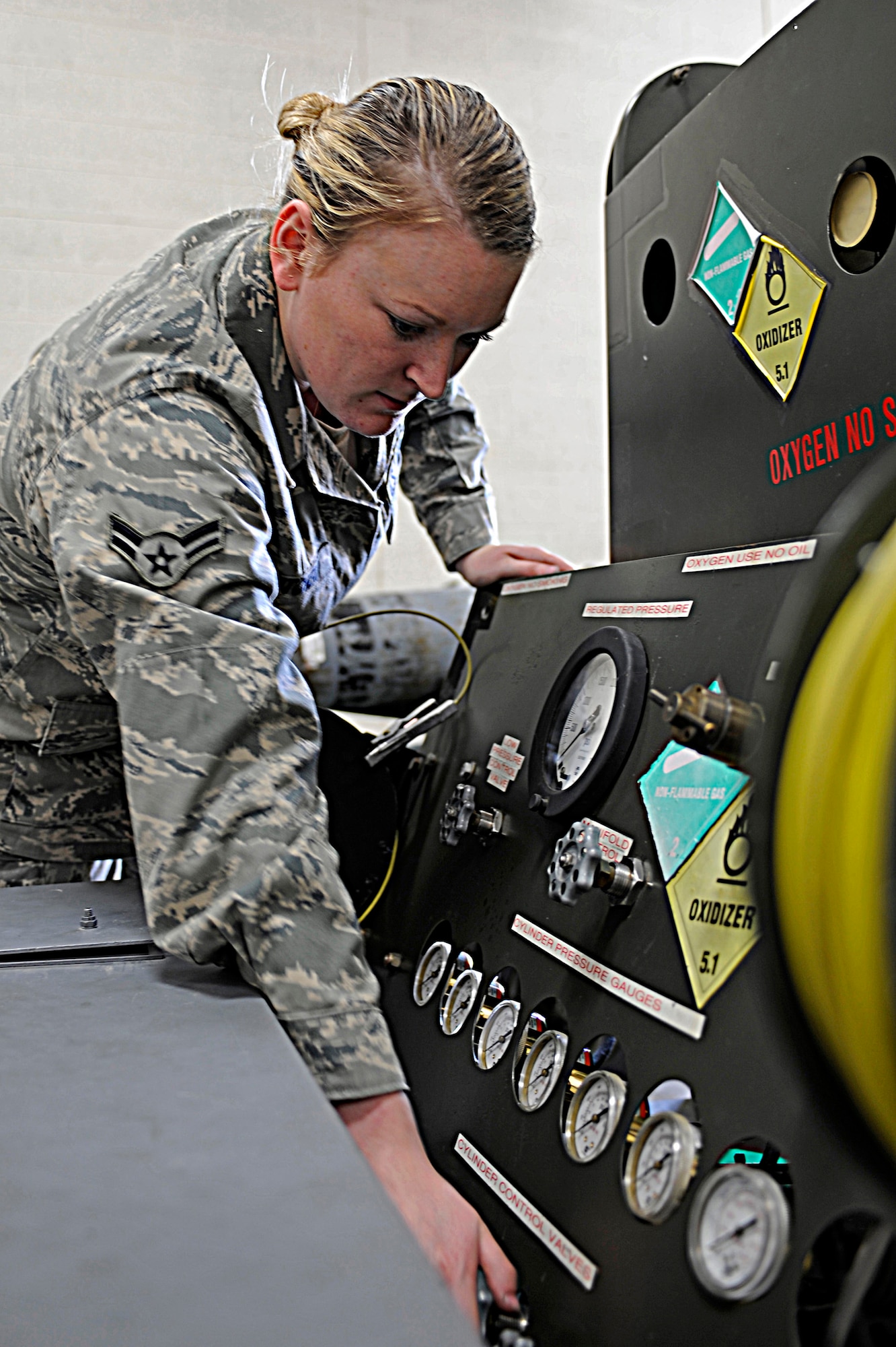 Airman 1st Class Christina Mitchem, 28th Maintenance Squadron electrical and environmental apprentice, turns off the valves of a gas-oxygen cart after a service check has been completed here, July 16.  The 28 MXS performs intermediate-level maintenance to support local B-1 training and worldwide taskings. (U.S. Air Force photo/Airman 1st Class Matthew Flynn)