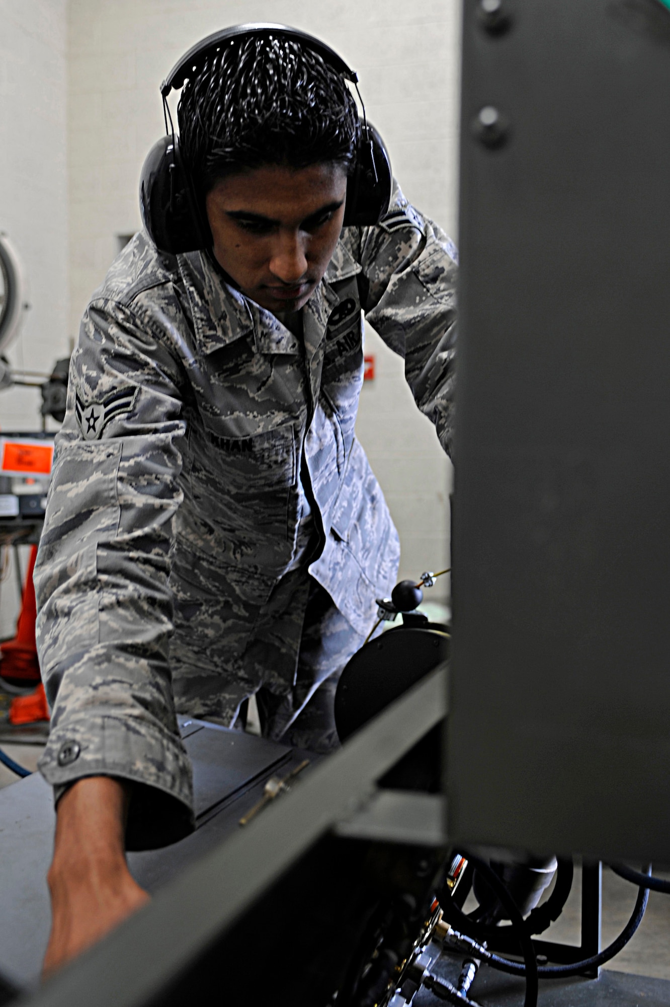 Airman 1st Class Zeeshan Khan, 28th Maintenance Squadron electrical and environmental journeyman, performs a service check on a gas-oxygen cart here, July 16. Airman Khan’s duty section is responsible for the maintenance on aircraft wiring and electrical controls, as well as required maintenance on B-1 environmental systems. (U.S. Air Force photo/Airman 1st Class Matthew Flynn)
