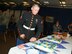 HURLBURT FIELD, Fla. -- Midshipman Colum Dunleavy cuts a cake with the 505th's ceremonial sword following a room dedication ceremony on July 16. The 505th Command and Control Wing dedicated the Col. Kevin W. Dunleavy Room in Building 90005 in honor of the man who had a vision of operational-level command and control having its own wing one day. Col. Dunleavy was the Midshipman's father. (U.S. Air Force photo/Keith Keel)