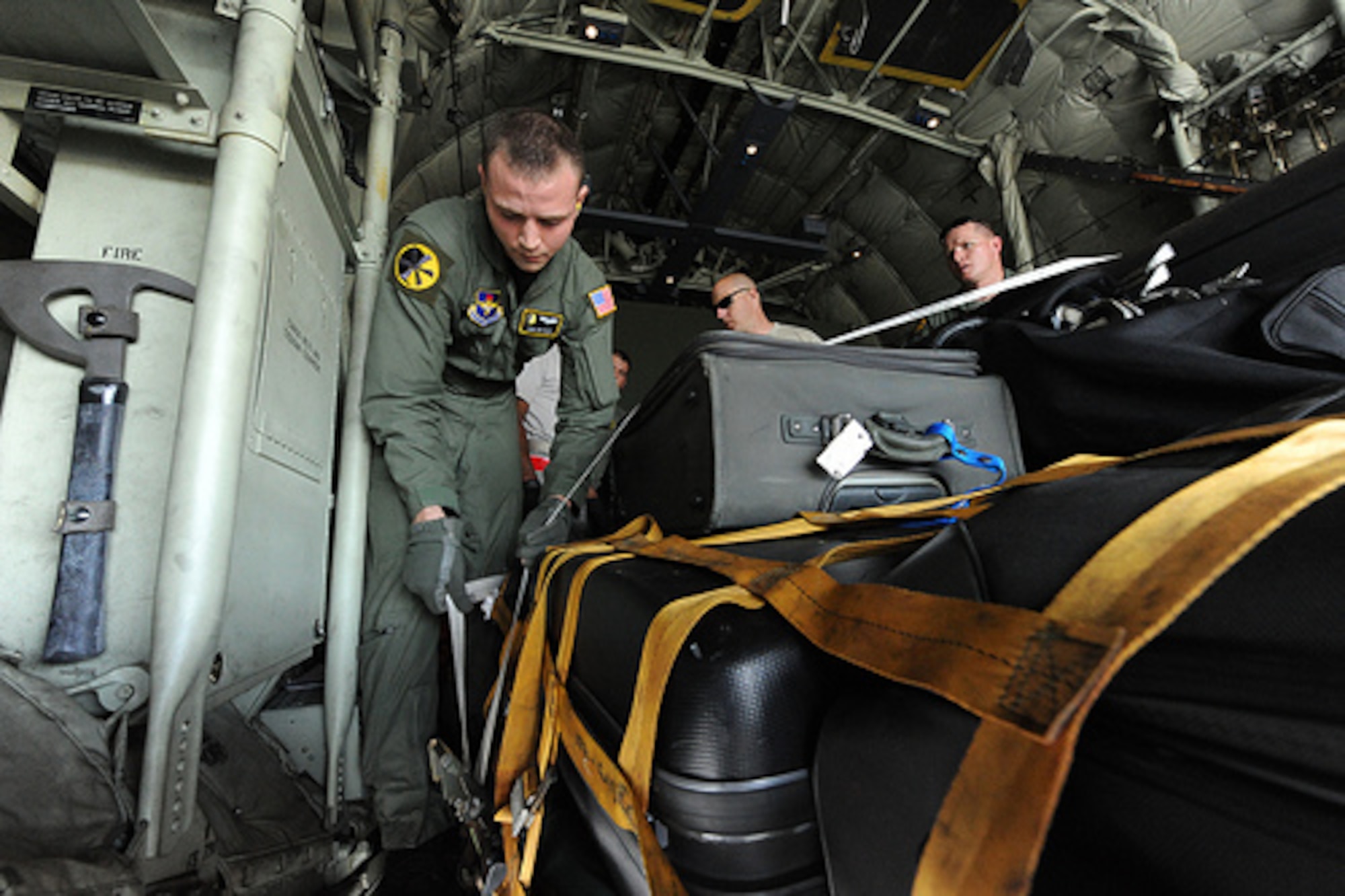Staff Sgt. Zac Nagy, a loadmaster assigned to the 48th Airlift Squadron,
Little Rock Air Force Base, Ark., secures a cargo strap before offloading
luggage and military equipment from a C-130 Hercules at McChord Air Force
Base, Wash., for Air Mobility RODEO 2009, July 18. RODEO is an international
combat skills and flying operations competition designed to develop and
improve techniques and procedures with our international partners to enhance
mobility operations. (U.S. Air Force photo by Staff Sgt. Christine Jones)