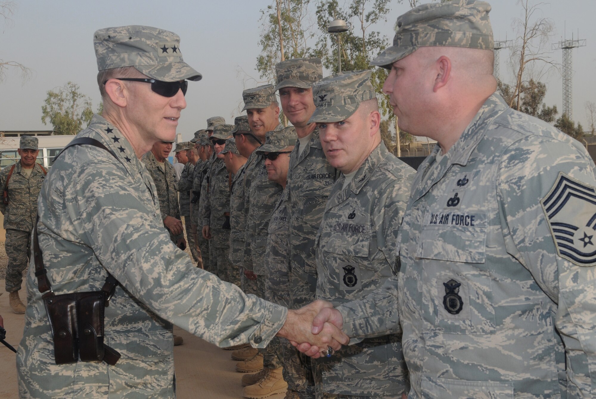 The Commander of Air Combat Command, Gen. John D. W. Corley, shakes hands with Chief Master Sgt. Lawrence Rettele at the 332nd Air Expeditionary Wing headquarters building July 16 at Joint Balad Base, Iraq. General Corley visited the installation to thank Joint Base Balad personnel for their service. Chief Rettele is assigned to the 332nd Expeditionary Security Forces Group. General Corley is also the commander of the Air Component of Joint Forces Command. (U.S. Air Force photo/Senior Airman Christopher Hubenthal)