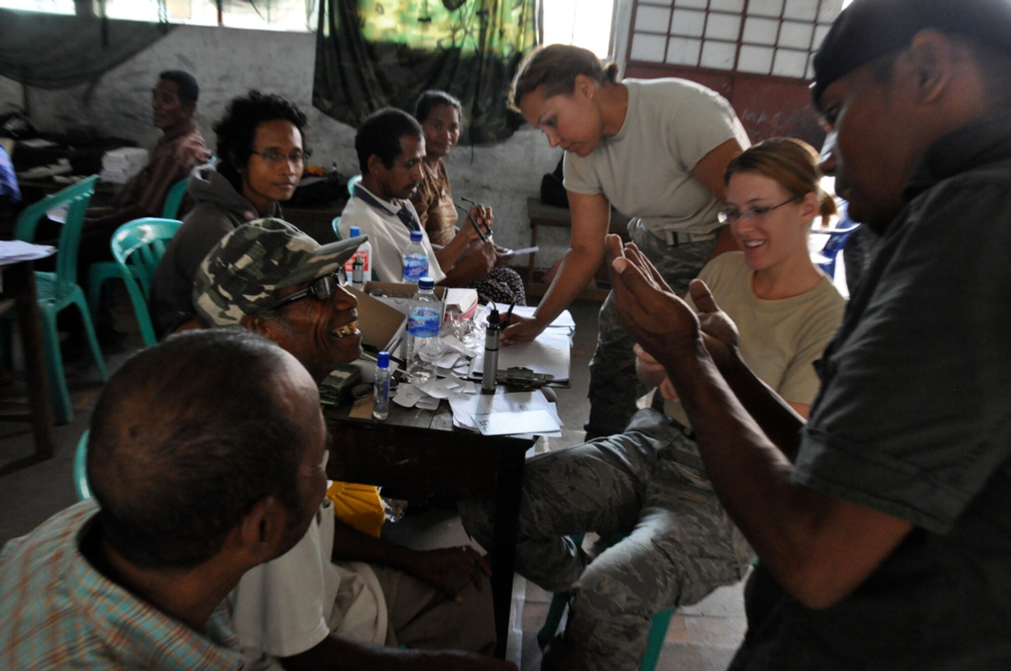 An East Timorese man smiles as he notices an improvement in his vision thanks to new glasses provided by Capt. Joni Scott-Weideman (center) and Staff Sgt. Jacqueline Cremmins (right) at a clinic in Dili, Timor Leste, July 20. The two Airmen are part of a total force eye specialist team deployed to Timor Leste as part of Operation Pacific Angel 2009. Pacific Angel is a Pacific Air Forces humanitarian assistance operation in the Asia-Pacific region led by 13th Air Force at Hickam Air Force Base, Hawaii. (U.S. Air Force photo/Tech. Sgt. Cohen A. Young)