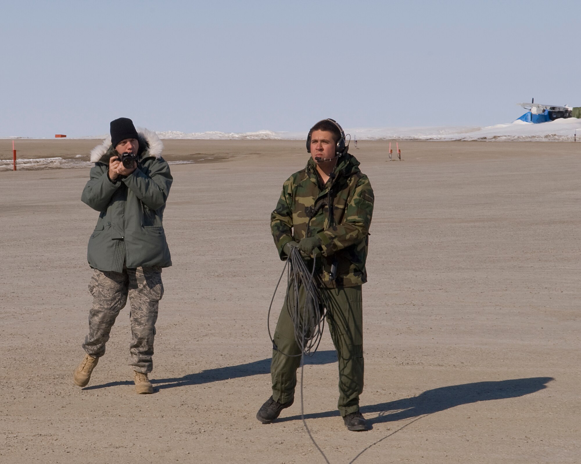 Tech. Sgt. Erik Gudmundson (left) a photojournalist with the 133rd Airlift Wing, pauses to take a photo of Senior Airman Corey Drabelis, 109th Airlift Squadron loadmaster as he sets to launch a Minnesota Air National Guard C-130 Hercules cargo aircraft in Cambridge Bay, Canada on May 29, 2009. The C-130 is delivering much needed supplies and providing transportation of vital equipment to support the Haughton-Mars Project in Resolute (HMP), Canada. HMP supports an exploration program aimed at developing new technologies, strategies, human's factors experience, and field-based operational know-how key to planning the future exploration of the Moon and Mars.
U.S. Air Force Photo by Senior Master Sgt. Mark Moss