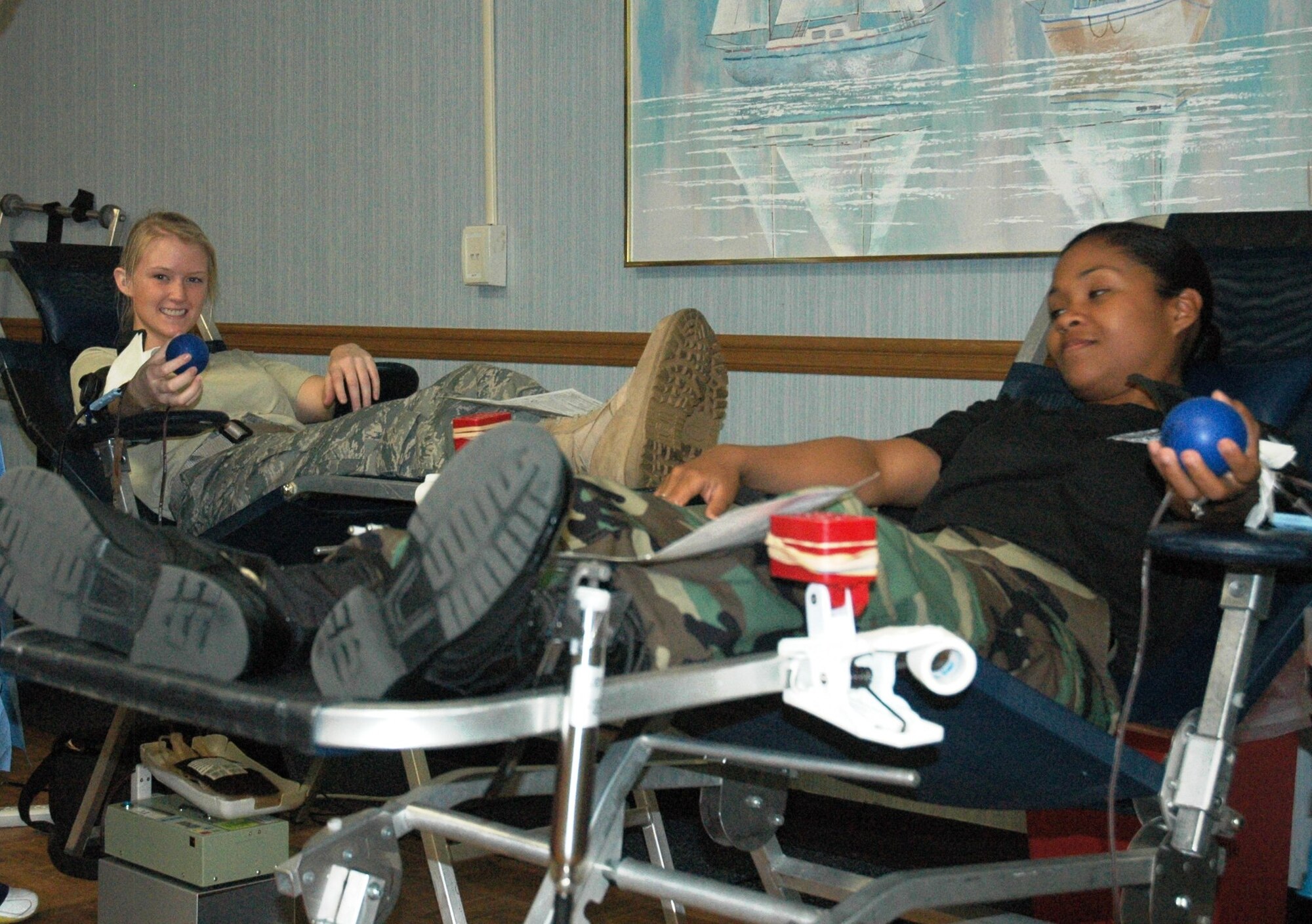 Airman 1st Class Dana Hildebrand, 325th Fighter Wing Ground Safety technician, and Staff Sgt. Erica Hudson, 325 FW Safety client support technician, donate blood during the Armed Services Blood Program blood drive July 16, at the Community Activities Center.  More than 120 Team Tyndall members showed up to support the blood drive, donating more than 100 units of blood for the Keesler Blood Donor Center Team which visits Tyndall on a quarterly basis.  (U.S. Air Force photo by Airman 1st Class Rachelle Elsea)