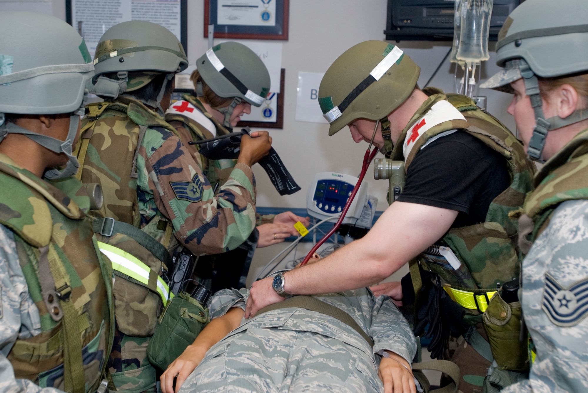 KUNSAN AIR BASE, Republic of Korea -- 8th Medical Group Airmen discuss a simulated patient during an exercise here July 20, 2009. Throughout the week, Wolf Pack Airmen, Soldiers and civilians will showcase their ability to survive and operate in simulated wartime contingencies by demonstrating how they defend the base, accept follow-on forces and take the fight north during an Operational Readiness Exercise. (U.S. Air Force photo by Senior Airman Jonathan Steffen) 