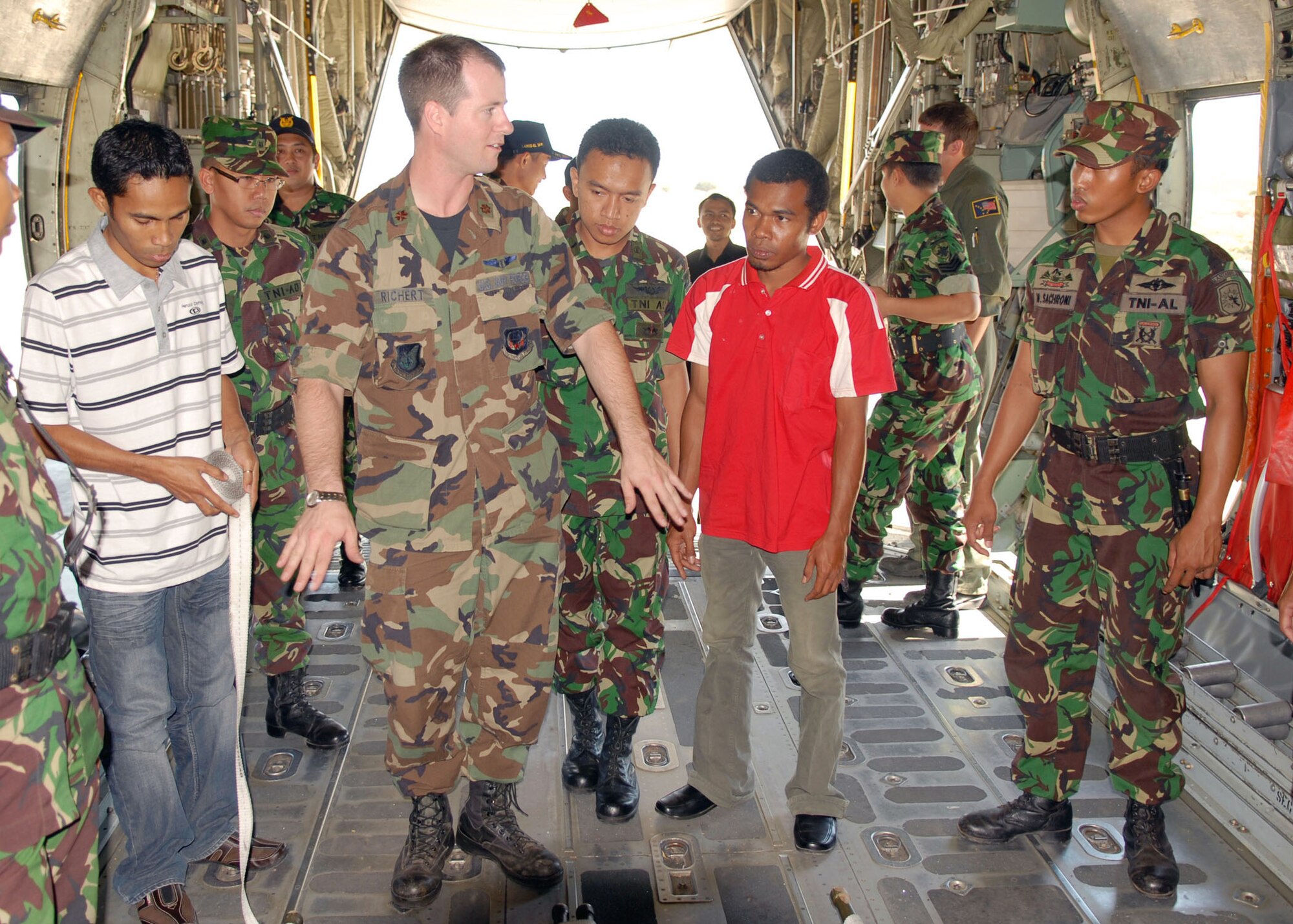 Maj. Greg Richert, a flight surgeon assigned to 13th Air Force at Hickam Air Force Base, Hawaii, briefs Indonesian military members and local doctors July 17 at El Tari Air Force Base, Indonesia, on how to air evacuate patients on C-130 aircraft. Major Richert, a flight surgeon assigned to 13th Air Force at Hickam Air Force Base, Hawaii, spent three days sharing classroom and hands-on training with Indonesian medical professionals as part of Operation Pacific Angel 2009.  Pacific Angel is a Pacific Air Forces humanitarian and civic assistance program conducted in the Asia-Pacific region and led by 13th Air Force at Hickam Air Force Base, Hawaii. (U.S. Air Force photo/Senior Master Sgt. Russell Dodson)