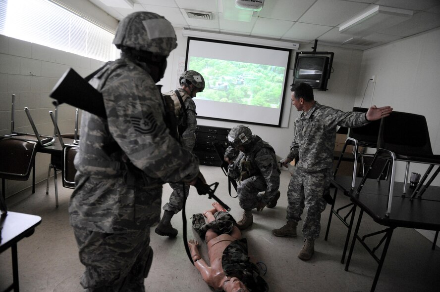 CAMP BLANDING, Fla. -- Sgt. 1st Class Gregory Mirones, 3rd Battalion, 211th Regiment, Regional Training Institute instructs Airmen on proper procedures while performing combat lifesaver skills during combat weather training here July 17. Combat lifesavers are non-medical personnel that can intervene and prevent death during combat situations. (U.S. Air Force photo by Senior Airman Gina Chiaverotti-Paige)