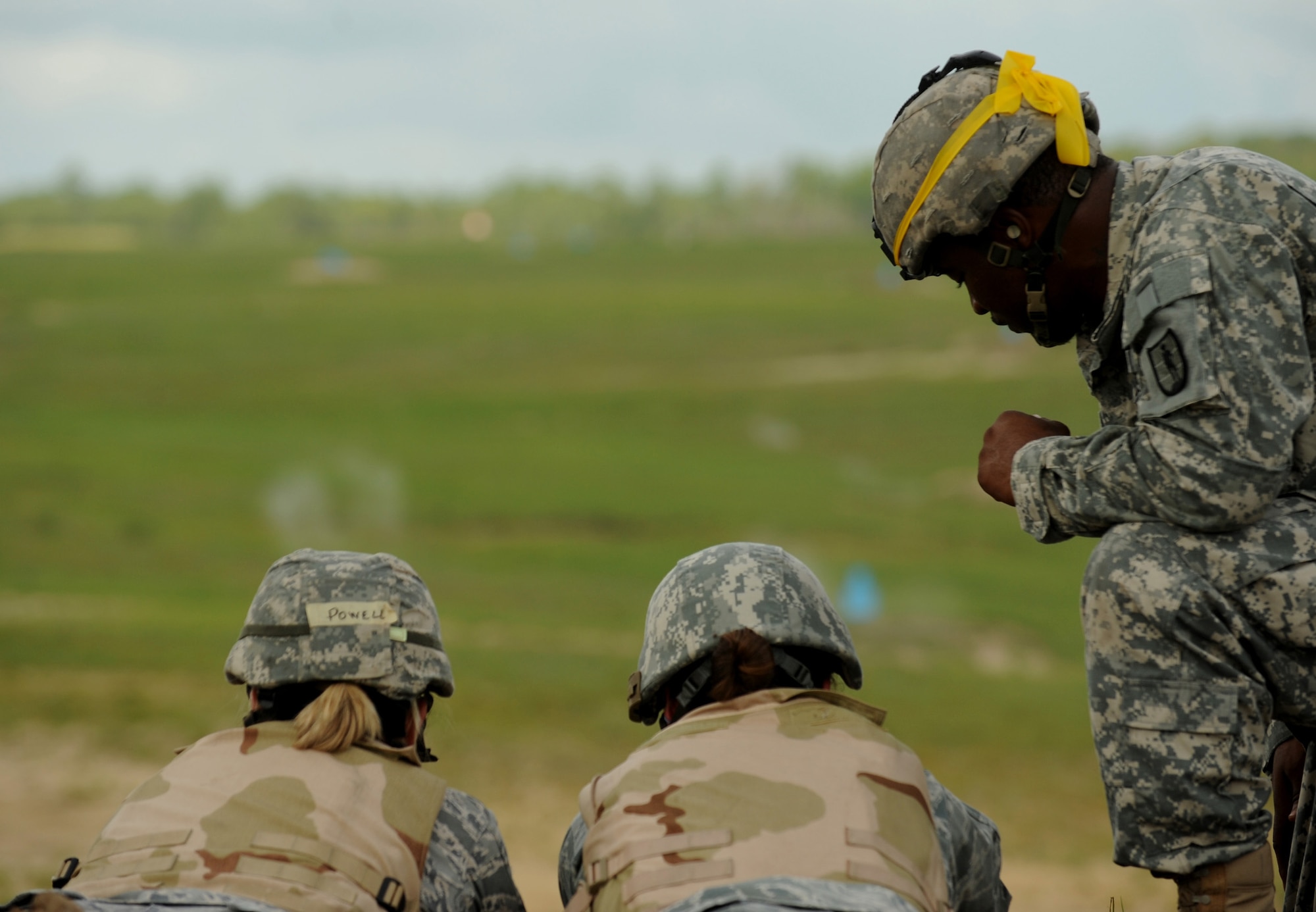 CAMP BLANDING, Fla. -- U.S. Army Staff Sgt. Edward Stokes, 211th Regiment, Regional Training Institute, instructs two Airmen on how to shoot the M249 Machine Gun during combat weather training at here July 16. The Airmen are in a 30-day course with U.S. Air Force and Army instructors. (U.S. Air Force photo by Senior Airman Gina Chiaverotti-Paige)