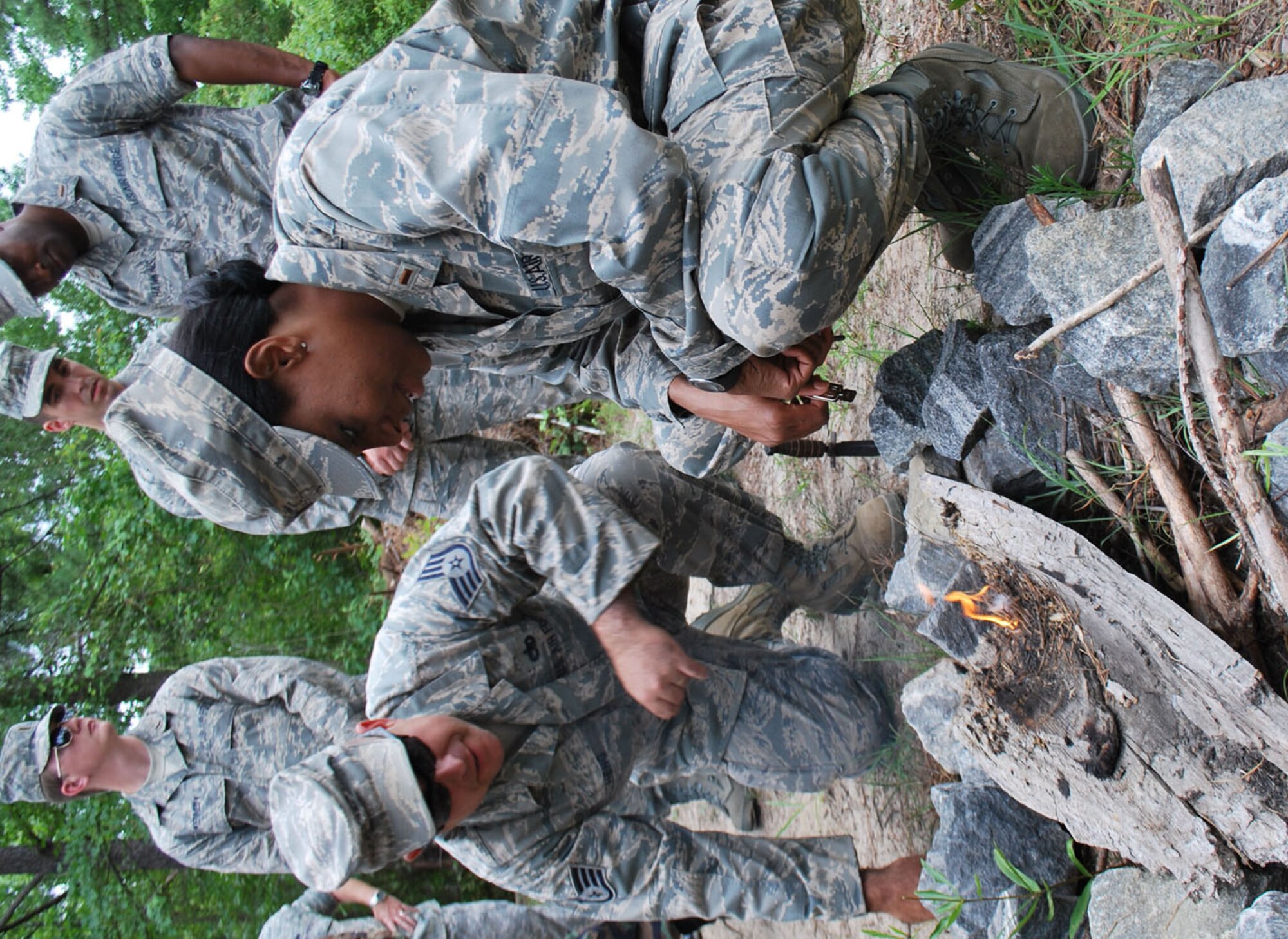 Second Lt. Regina Davis (right), a chaplain candidate, learns how to start a fire using flint from Staff Sgt. Leonardo Heng, a Combat Readiness School instructor with the 5th Combat Communications Support Squadron. Sergeant Heng gave the chaplain candidates an introduction to basic survival skills during a tour at Robins Air Force Base, Ga., July 13, 2009. (U.S. Air Force photo/Staff Sgt. Celena Wilson)