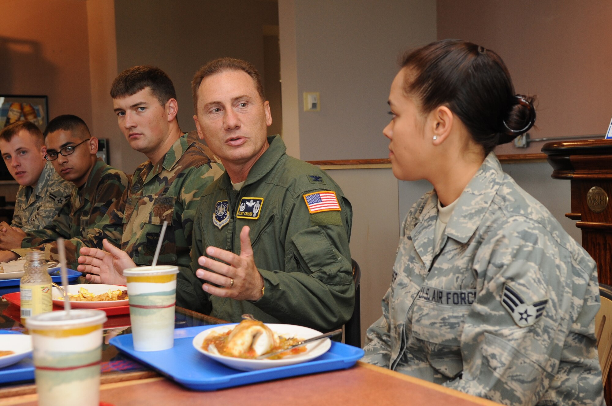 BUCKLEY AIR FORCE BASE, Colo. -- Col. Clint Crosier, 460th Space Wing commander, talks with Senior Airman Stephanie Swisher, 460th Civil Engineering Squadron, during a junior enlisted breakfast July 7. Colonel Crosier called the breakfast a chance to speak with younger Airmen in an informal setting. He plans to meet informally with outher groups in the future. (U.S. Air Force photo by Senior Airman John Easterling)