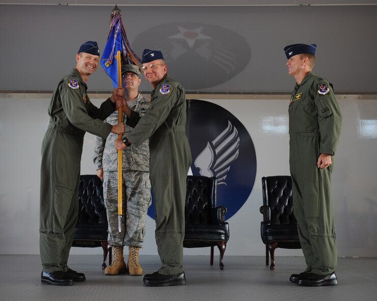 MOODY AIR FORCE BASE, Ga. -- Col. Michael O'Dowd, 23rd Fighter Group outgoing commander, hands over the guidon to Col. Gary Henderson, 23rd Wing commander, at the 23rd FG change of command ceremony here July 20. Colonel O'Dowd has been the 23rd FG commander for two years. (U.S. Air Force photo by Tech. Sgt. Jeffrey Allen)