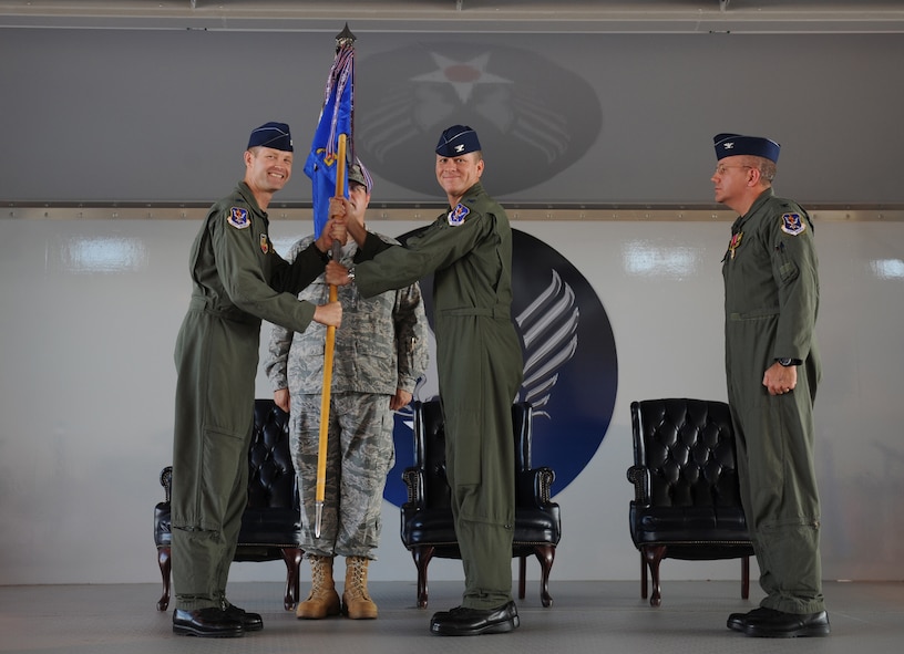 MOODY AIR FORCE BASE, Ga. -- Col. Ellwood Hinman IV, 23rd Fighter Group incoming commander, receives the guidon from Col. Gary Henderson, 23rd Wing commander, during the 23rd FG change of command ceremony here July 20. The 23rd FG directs the flying operations of the largest A-10 fighter organization in the Air Force. (U.S. Air Force photo by Tech.  Sgt.  Jeffrey Allen)