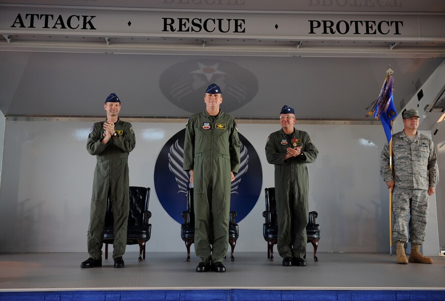 MOODY AIR FORCE BASE, Ga. -- Col. Gary Henderson, 23rd Wing commander, and Col. Michael O'Dowd, 23rd Fighter Group outgoing commander, applaud after Col. Ellwood Hinman IV took reigns of the 23rd FG during a change of command ceremony here July 20. (U.S. Air Force photo by Tech. Sgt. Jeffrey Allen)