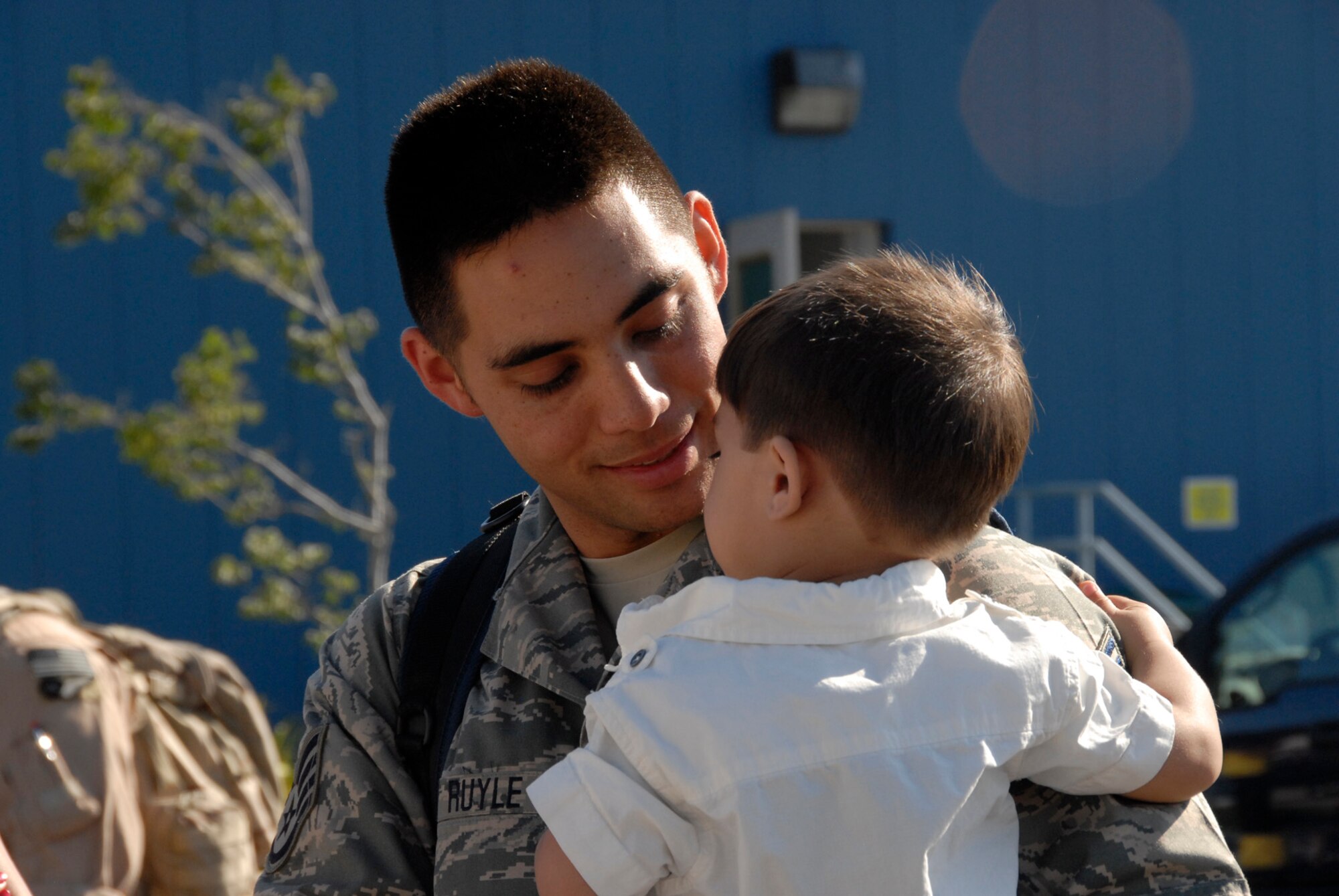 Staff Sgt. Michael Ruyle, an avionics specialist from the 129th Maintenance Squadron, spends time with his son upon his return home to Moffett Federal Airfield, Calif., after a two-month deployment to Afghanistan, July 9.  (Air National Guard photo by Tech. Sgt. Ray Aquino)(RELEASED)