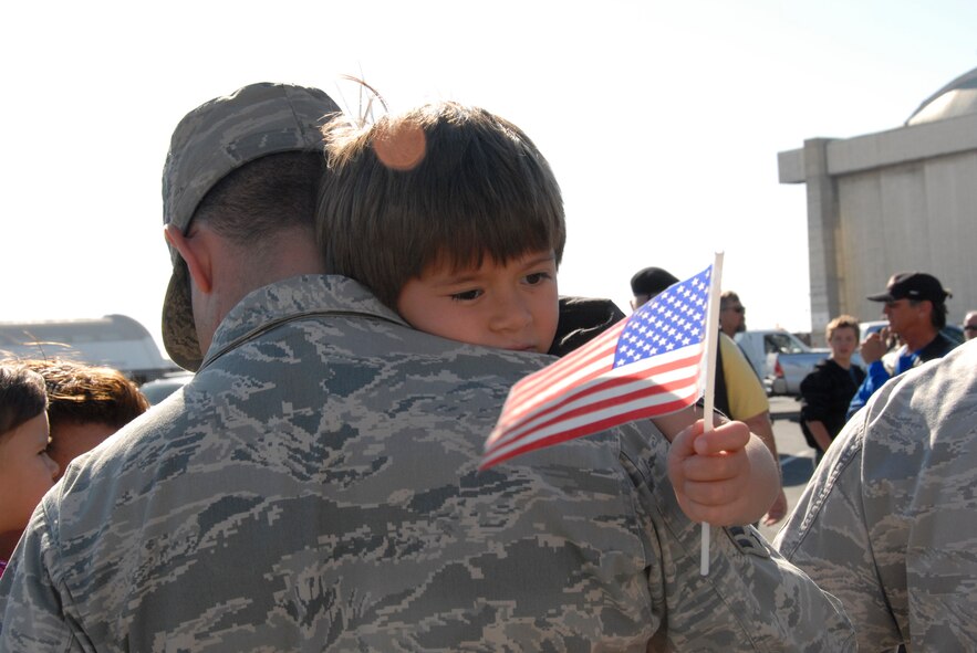 Senior Airman Darren Gray, an aircraft maintenance specialist from the 129th Maintenance Squadron, is given a hug from his son upon his return home to Moffett Federal Airfield, Calif., after a two-month deployment to Afghanistan, July 9.  (Air National Guard photo by Tech. Sgt. Ray Aquino)(RELEASED)
