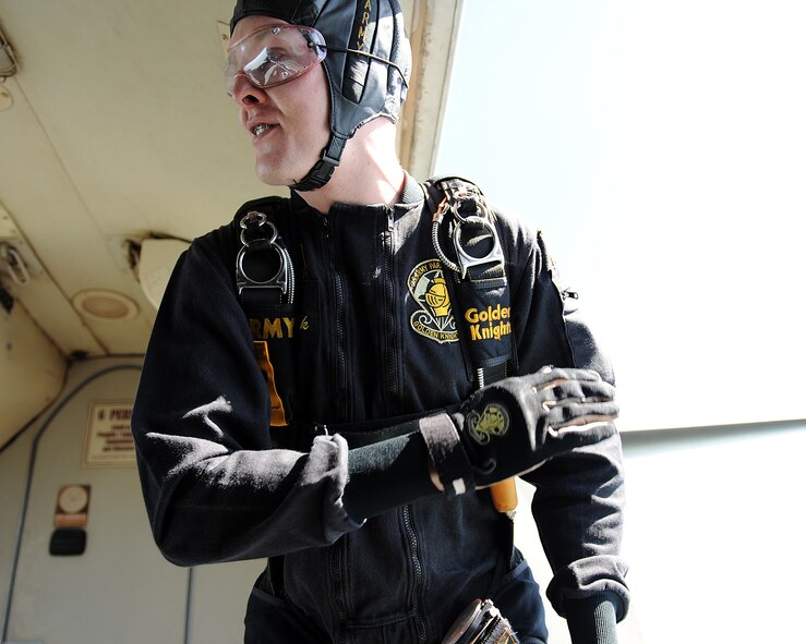 MINOT AIR FORCE BASE, N.D. -- Sgt. Daniel Cook, a member of the United States Army Parachute Team the Golden Knights, counts down the final seconds prior to jumping out the aircraft during the open house here July 18, 2009. The Golden Knights conduct parachute demonstrations, tandem jumps and compete in national and international competitions in support of the U.S. Army Accessions Command's tactical, operational, and strategic missions; creating a greater propensity to serve in the U.S. Army, while connecting America with America's Army. (U.S. Air Force photo by Tech. Sgt. Linda C. Miller)