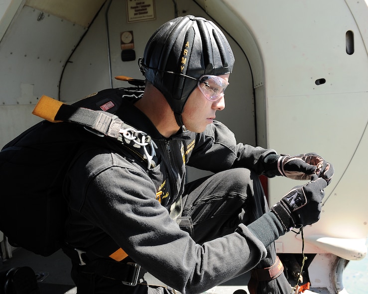MINOT AIR FORCE BASE, N.D. -- Sgt. Ryan Bonham, a member of the United States Army Parachute Team the Golden Knights, prepares the string that he will pull to release his smoke while in freefall during the open house here July 18, 2009. The Golden Knights conduct parachute demonstrations, tandem jumps and compete in national and international competitions in support of the U.S. Army Accessions Command's tactical, operational, and strategic missions; creating a greater propensity to serve in the U.S. Army, while connecting America with America's Army. (U.S. Air Force photo by Tech. Sgt. Linda C. Miller)