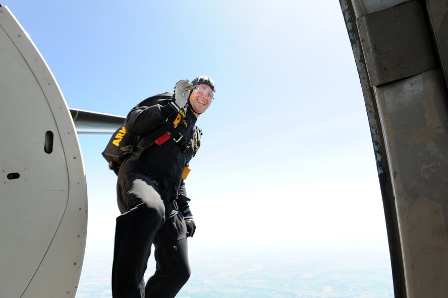 MINOT AIR FORCE BASE, N.D. -- Staff Sgt. Andrew Starr, a member of the United States Army Parachute Team the Golden Knights, gives a farewell wave after jumping out of the aircraft for a freefall performance during the open house here July 18, 2009. The Golden Knights conduct parachute demonstrations, tandem jumps and compete in national and international competitions in support of the U.S. Army Accessions Command's tactical, operational, and strategic missions; creating a greater propensity to serve in the U.S. Army, while connecting America with America's Army. (Official photo by Tech. Sergeant Linda C. Miller)