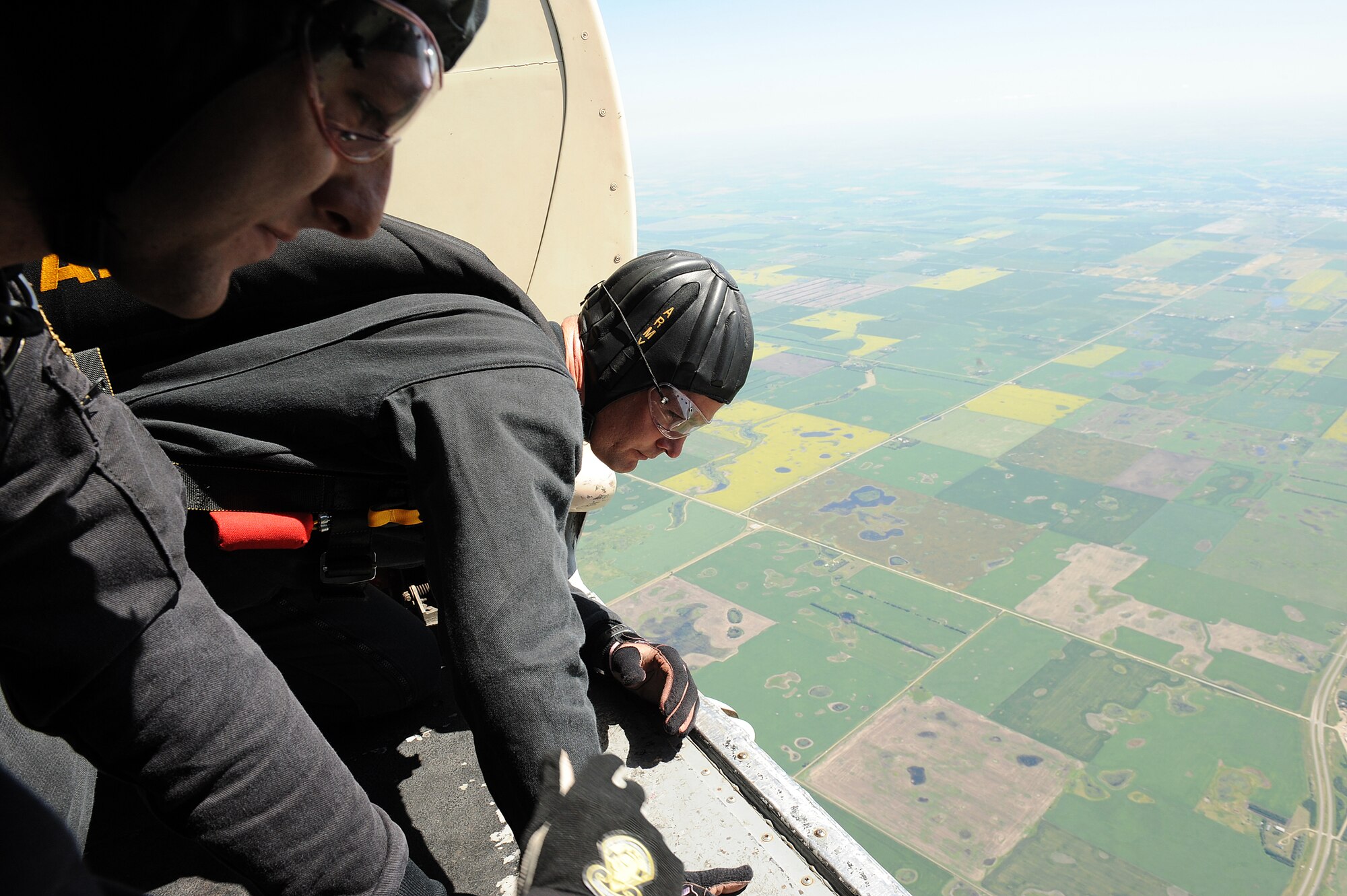 MINOT AIR FORCE BASE, N.D. -- Sgt. Aaron Figel (right) and Staff Sgt. Andrew Starr (left), members of the United States Army Parachute Team the Golden Knights, peer over the edge of the aircraft to spot the ground target prior to their freefall jumps during the open house here July 18, 2009. The Golden Knights conduct parachute demonstrations, tandem jumps and compete in national and international competitions in support of the U.S. Army Accessions Command's tactical, operational, and strategic missions; creating a greater propensity to serve in the U.S. Army, while connecting America with America's Army. (U.S. Air Force photo by Tech. Sgt. Linda C. Miller)