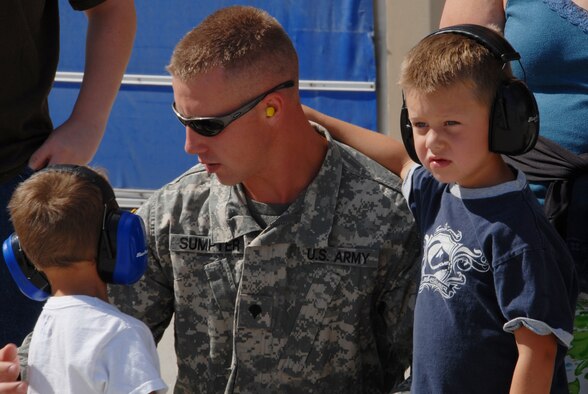 Specialist Sumpter from the Idaho Army National Guard and his two sons watch F-15 aircraft fly out of Gowen Field Air Base during a tour of an Oregon Air Guard 173 Fighter Wing aircraft on July 12, 2009. (Air Force photo by Tech Sgt Becky Vanshur)(Released)