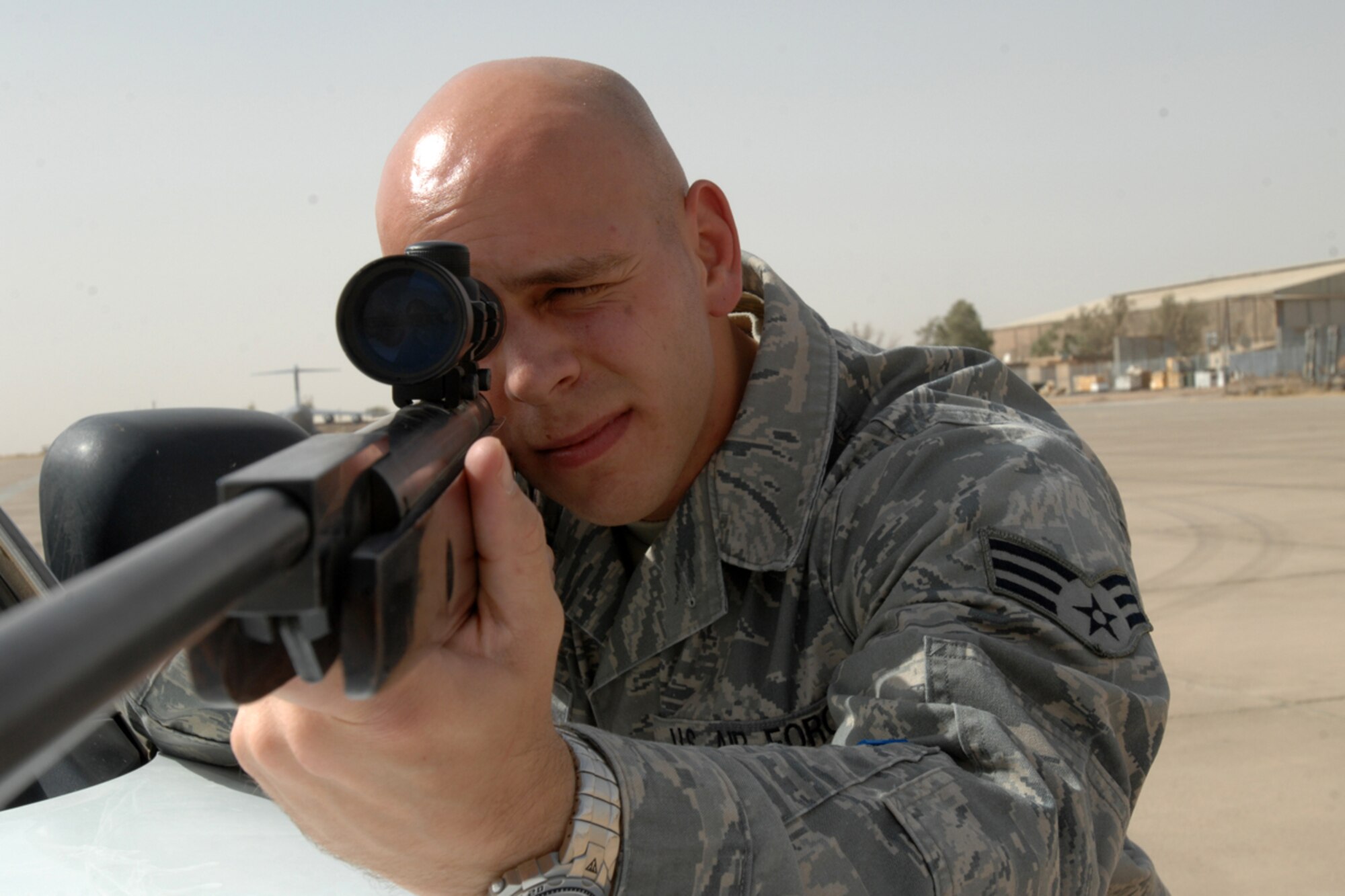 Senior Airman Wesley Walcynski, 506th Expeditionary Operations Support Squadron, Airfield Management, takes aim with an air rifle used to keep the flightline here free from wildlife July 14. The Valparaiso, Ind., native is the "Warrior of the Week" for the 506th Air Expeditionary Group. He is deployed here from the 354th Operations
Support Squadron, Eielson Air Force Base, Alaska. (U.S. Air Force photo by
Staff Sgt. Joshua Breckon)
