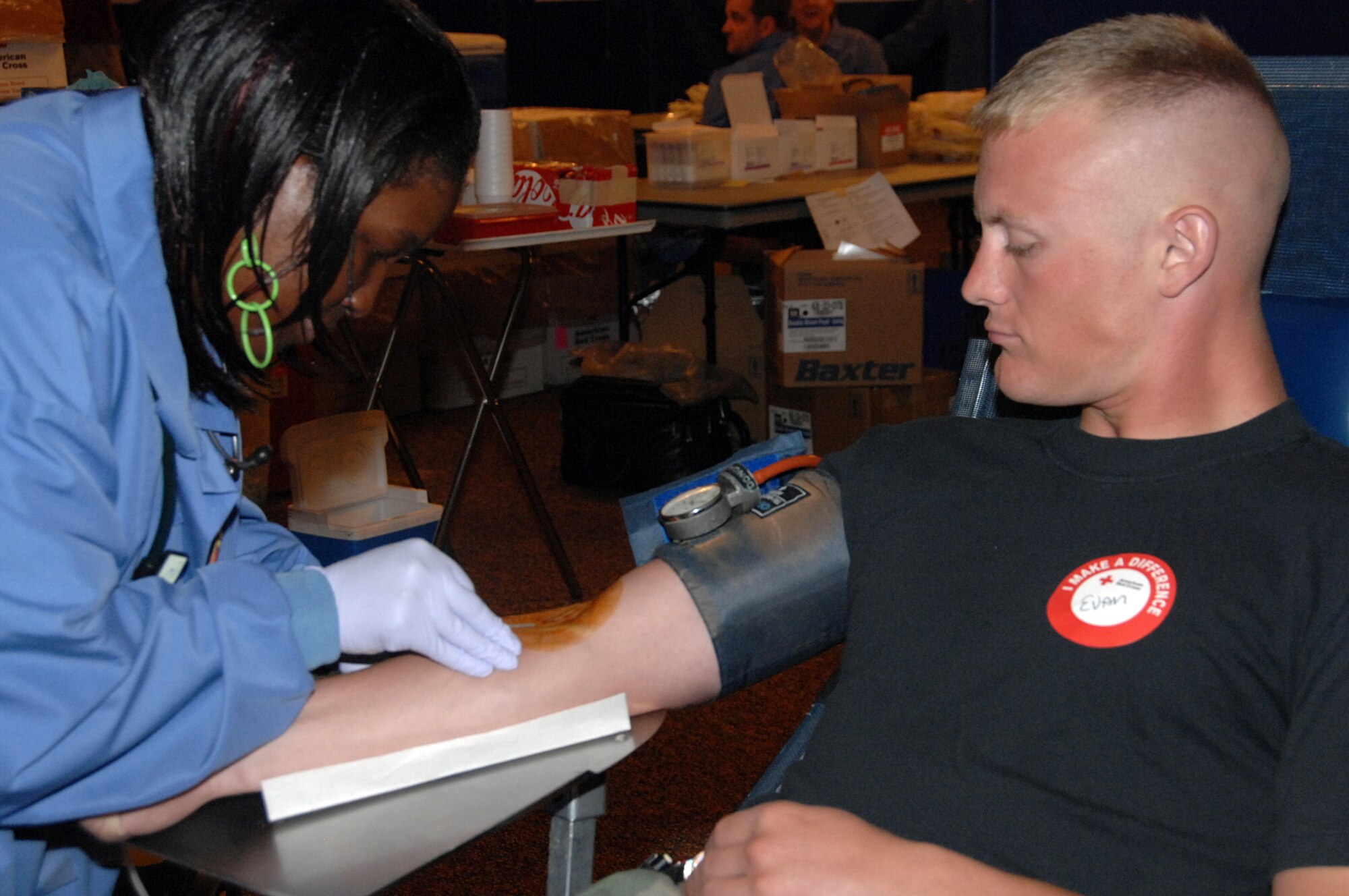 OFFUTT AIR FORCE BASE, Neb. -- Juanita Jerkins, a Red Cross phlebotomist, draws blood from Senior Airman Evan Friedrich, 1st Aircraft Maintenance Unit, during a blood drive at the Community Center here July 16.
