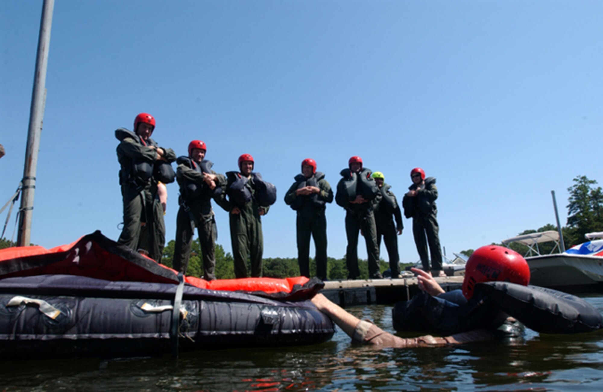SHAW AIR FORCE BASE, S.C. -- Senior Airman Justin Carson, 20th Fighter Wing survival evasion resistance and escape specialist,demonstrates to 20th FW pilots how to board a one-man liferaft during water survival training at Lake Wateree State Park recently. SERE Specialists train aircrew and other high-risk personnel on how to survive in many different scenarios. (U.S. Air Force photo/Senior Airman Matt Davis)