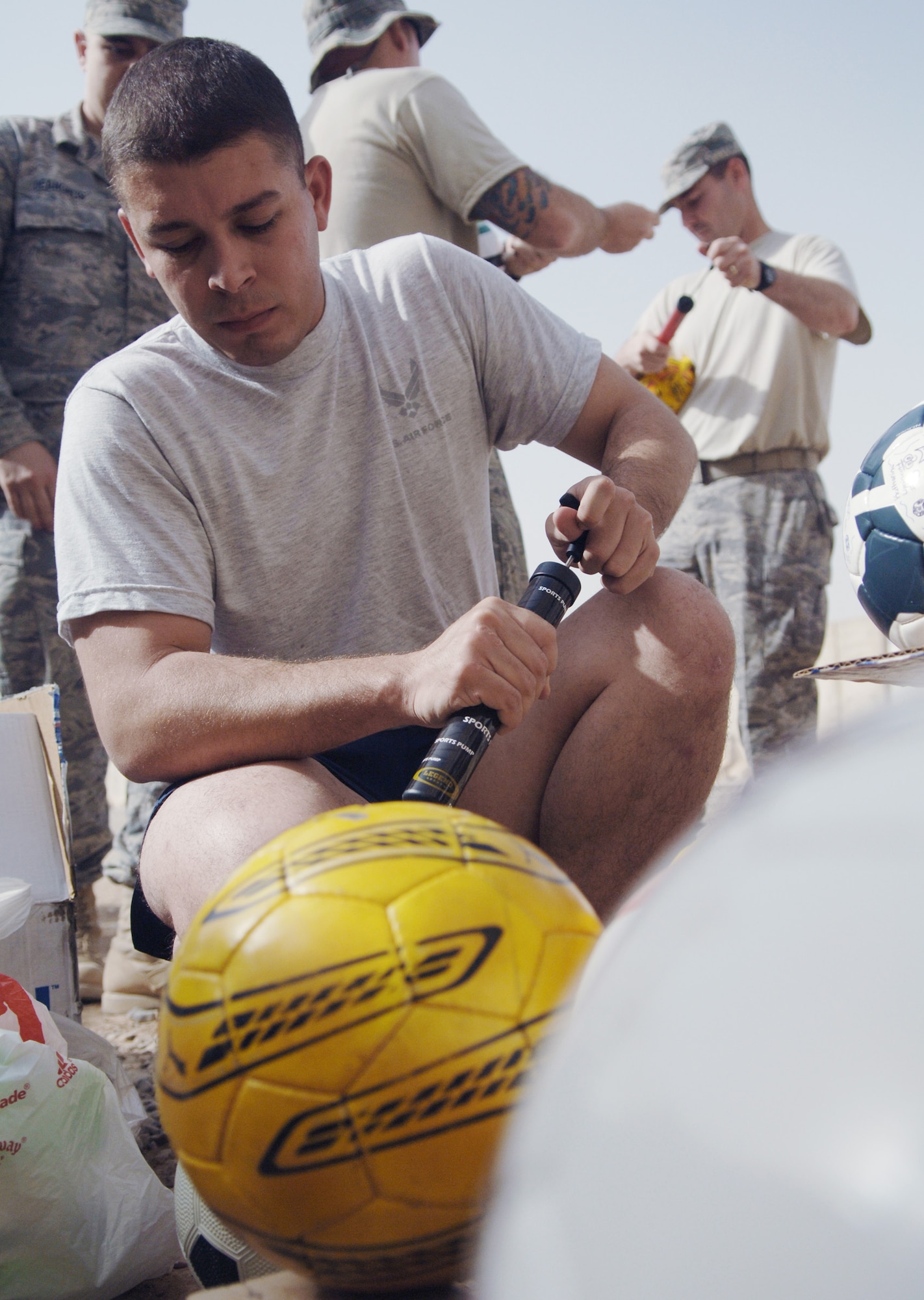 Airman 1st Class Jefferson Aguiar inflates a soccer ball July 15 at Joint Base Balad, Iraq. The Pennsylvania State University chapter of the Phi Kappa Tau fraternity sponsored a donation drive at a soccer tournament in June, and then shipped the balls here for distribution. Airman Aguiar is assigned to the 727th Expeditionary Air Control Squadron. (U.S. Air Force photo/Senior Airman Christopher Hubenthal) 
