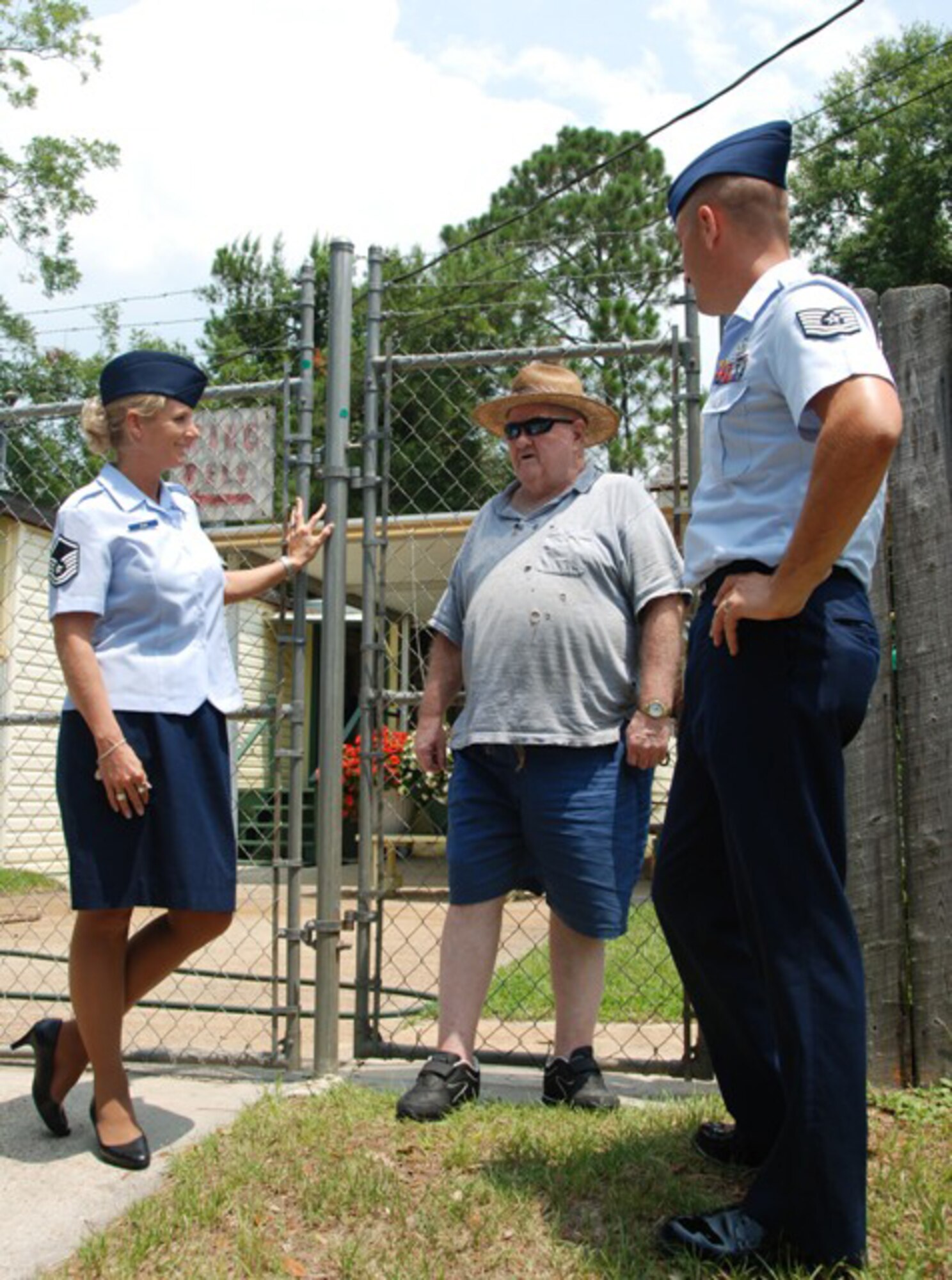 Master Sgt. Wendy Gehri and Tech. Sgt. Joe Ezell, members of America's AOC, talk with Mr. Edwin Terry after delivering food to his house as a part of the Bay County Council on Aging Meals on Wheels program. (US Air Force Photo by: 1st Lt. Jared Scott)