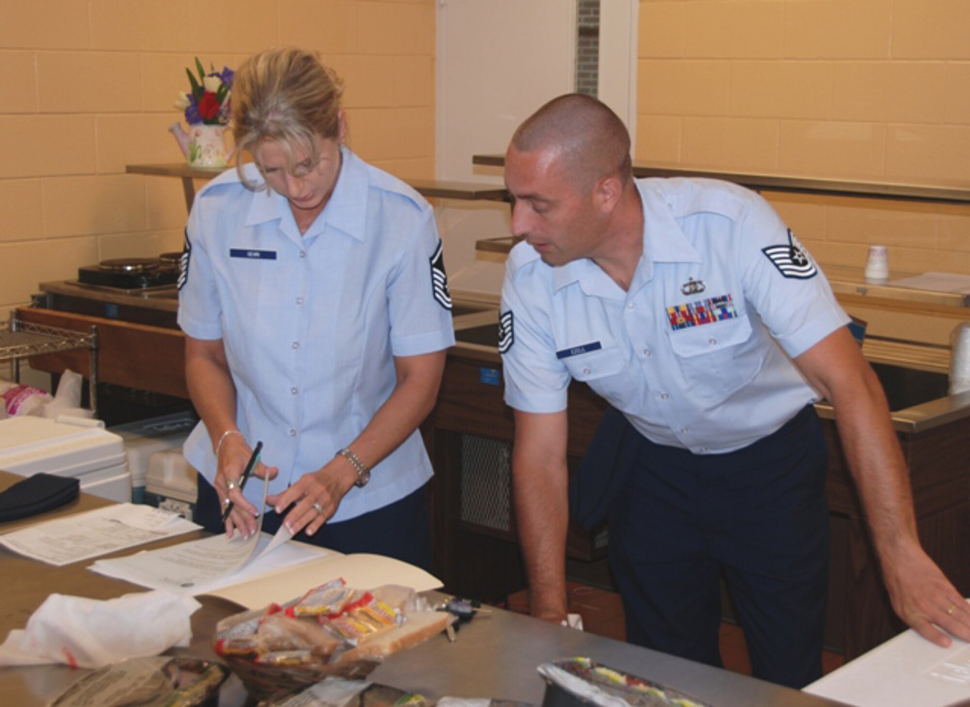 Master Sgt. Wendy Gehri and Tech. Sgt. Joe Ezell, members of America's AOC, prepare their delivery route while volunteering with the Bay County Council on Aging Meals on Wheels program. (US Air Force Photo by: 1st Lt. Jared Scott)