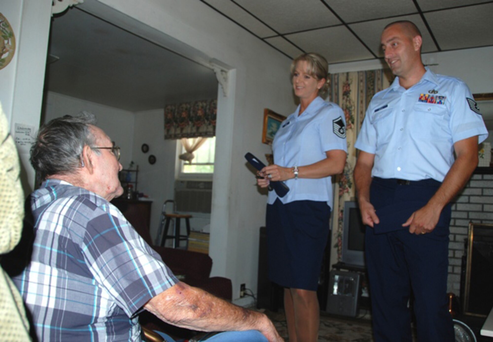 Master Sgt. Wendy Gehri and Tech. Sgt. Joe Ezell, members of America's AOC, talk with Mr. Laurice Hand after delivering food to his house as a part of the Bay County Council on Aging Meals on Wheels program. (US Air Force Photo by: 1st Lt. Jared Scott)