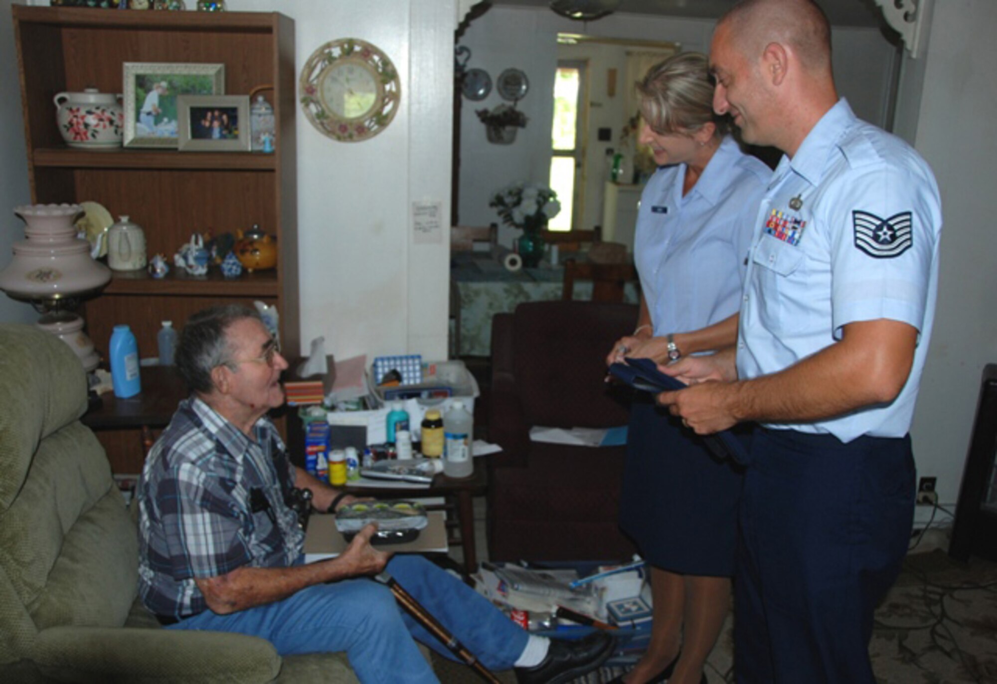 Master Sgt. Wendy Gehri and Tech. Sgt. Joe Ezell, members of America's AOC, talk with Mr. Laurice Hand after delivering food to his house as a part of the Bay County Council on Aging Meals on Wheels program. (US Air Force Photo by: 1st Lt. Jared Scott)
