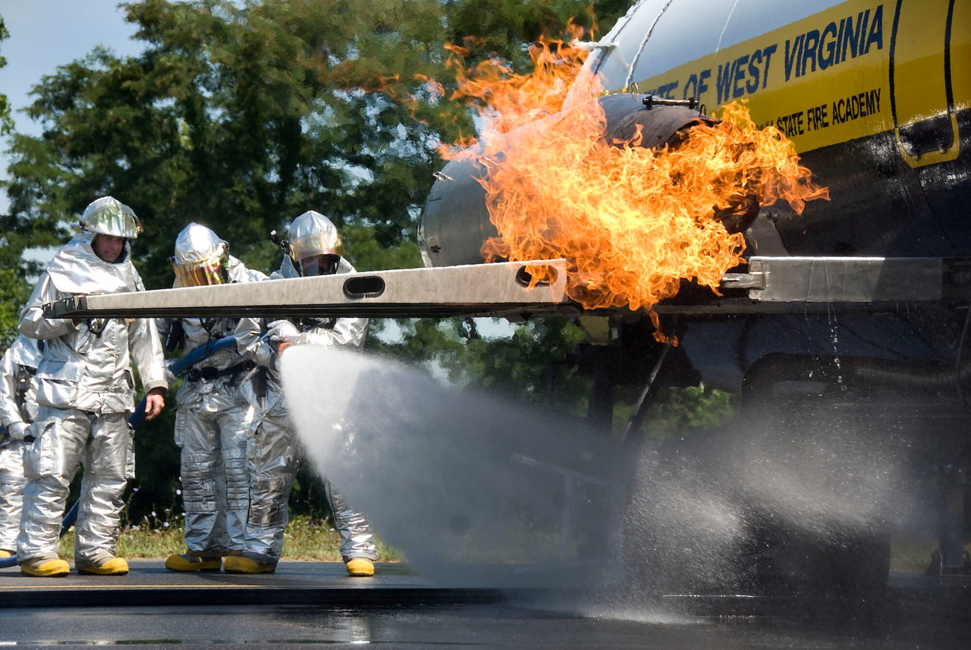 167th Airlift Wing firefighters extinguish a fire in the landing gear of a simulated aircraft during a training exercise at the Martinsburg, WVa air base on Wednesday, July 15, 2009. The West Virginia State Fire Academy provided the training for firefighters to become certified on Aircraft Firefighting or ARFF which is an annual requirement. (U.S. Air Force photo by Master Sgt Emily Beightol-Deyerle)