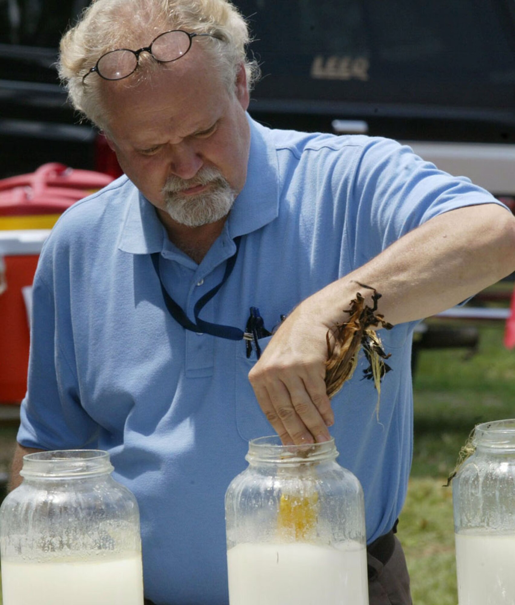 Donald “Vince” Curry of the 94th Communications Flight, butters up an ear of corn during the annual Corn and Sausage Roast held at Dobbins Lakeside July 15. The event featured grilled sausages, grilled corn and a mini car show. The annual fund raising event is held in support of Family Emergency Services, which provides aide to employees during emergencies. (U.S. Air Force photo/Don Peek)
