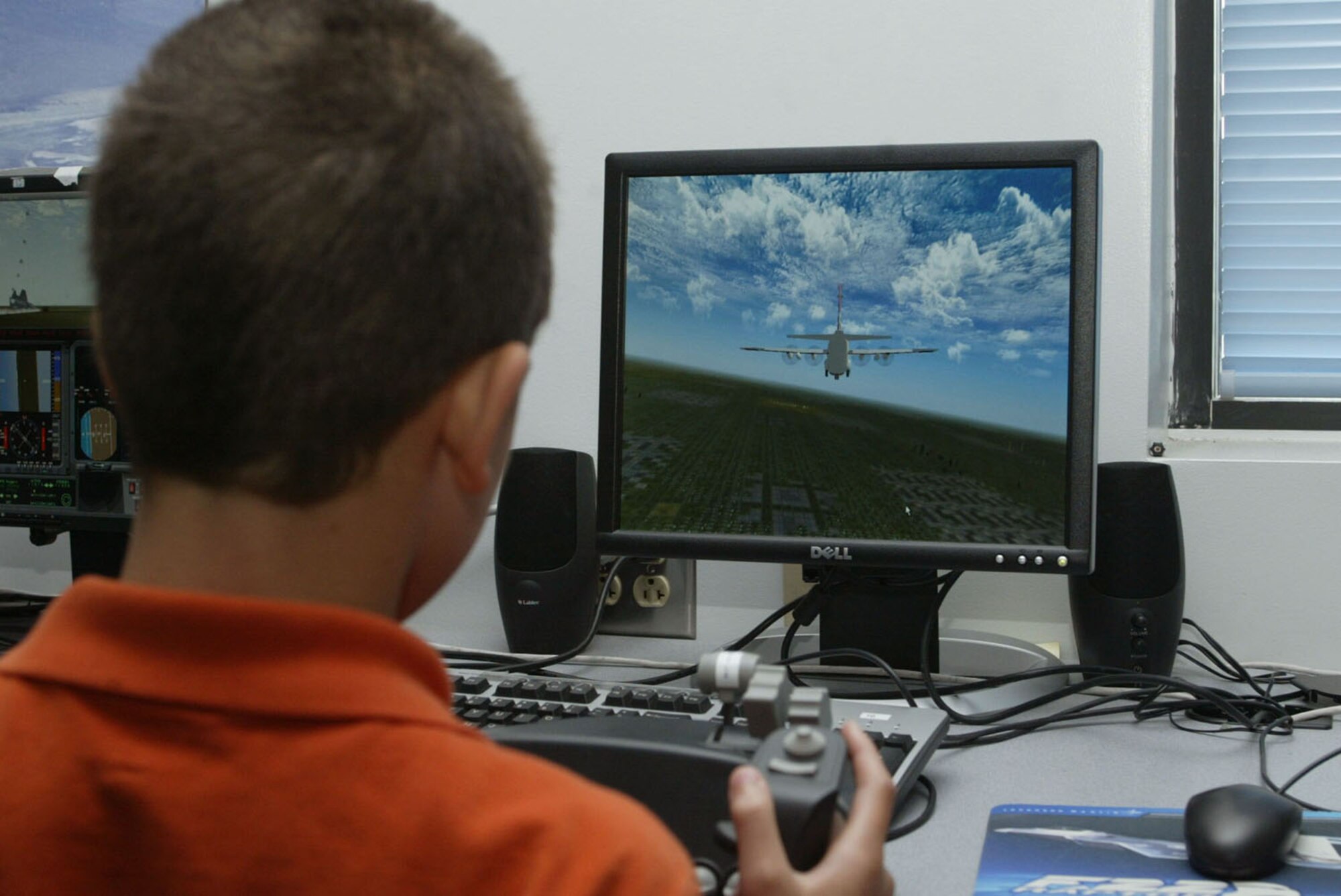 Students from the STARBASE Program have the opportunity to practice their flying skills on the various flight simulators on base. The four-day program taught children of DoD members about science, math, technology and aviation. (U.S. Air Force photo/Don Peek)