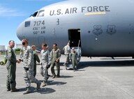 Aircrew members from McChord AFB, Wash., greet Airmen from the 512th and 436th Airlift Wings, Dover Air Force Base, Del., upon their arrival July 18 for the Air Mobility Command RODEO. Team Dover will be tested on many airlift operation aspects including aerial port, maintenance, security forces and air crew events. (U.S. Air Force photo/Staff Sgt. Steve Lewis)