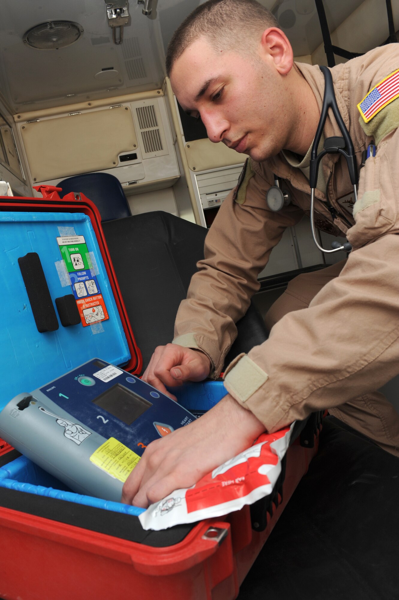 SOUTHWEST ASIA - Senior Airman Eddie Cuza, 964th Expeditionary Airborne Air Control Squadron, inspects an ambulance defibrillator as part of his routine equipment checks July 17. Airman Cuza is one of two Squadron Medical Element members while deployed out of Tinker Air Force Base, Okla., and hails from Edison, N.J. (U.S. Air Force photo Tech. Sgt. Charles Larkin Sr)
