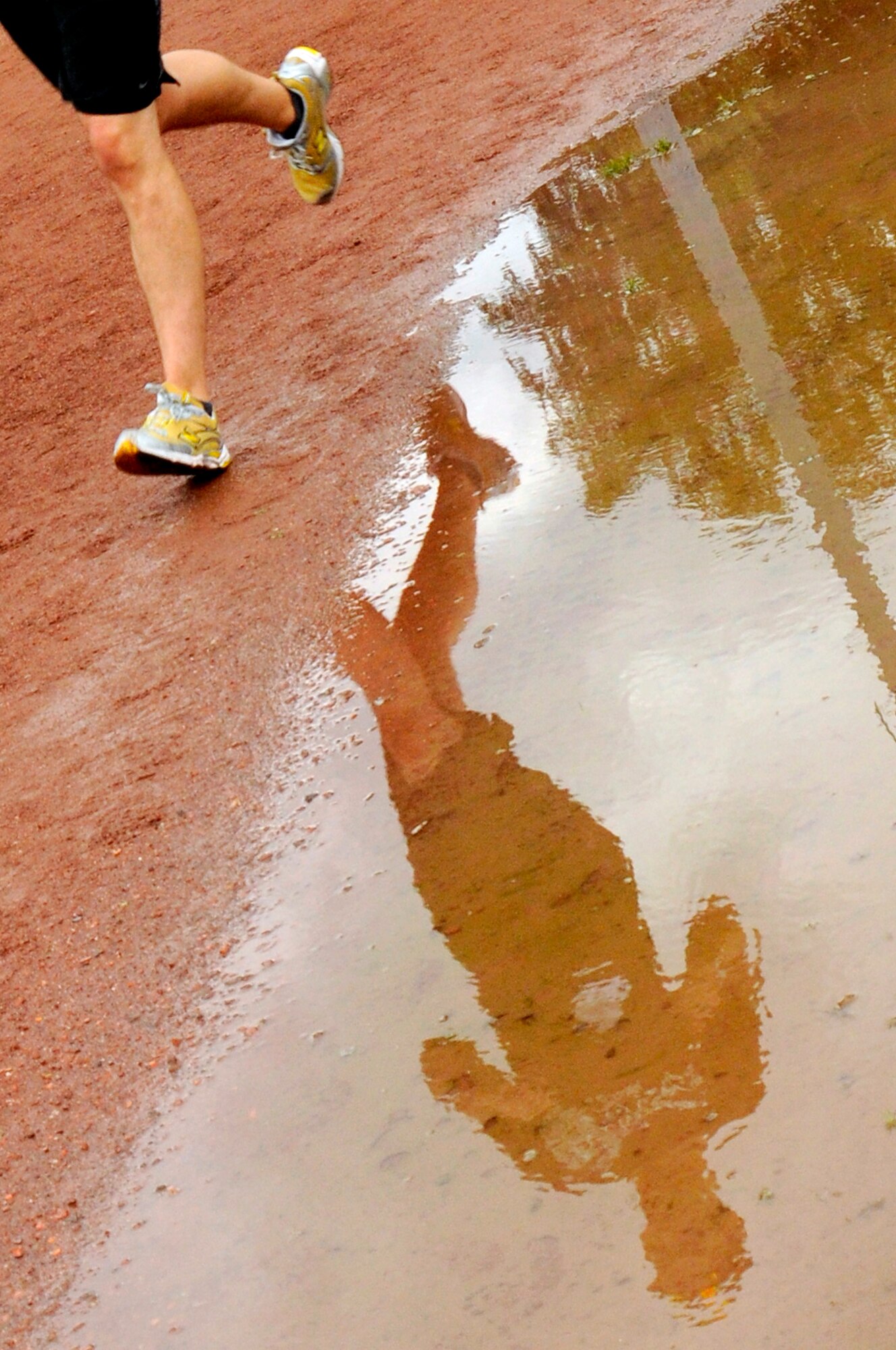 A participant continues to run after it rains during the Viking Challenge at Vogelweh Military Complex track, July 17, 2009. The Viking Challenge is an annual event that is held to raise money for the two Fisher Houses located on Landstuhl Regional Medical Center. (U.S. Air Force photo by Tech. Sgt. Kenneth Bellard)