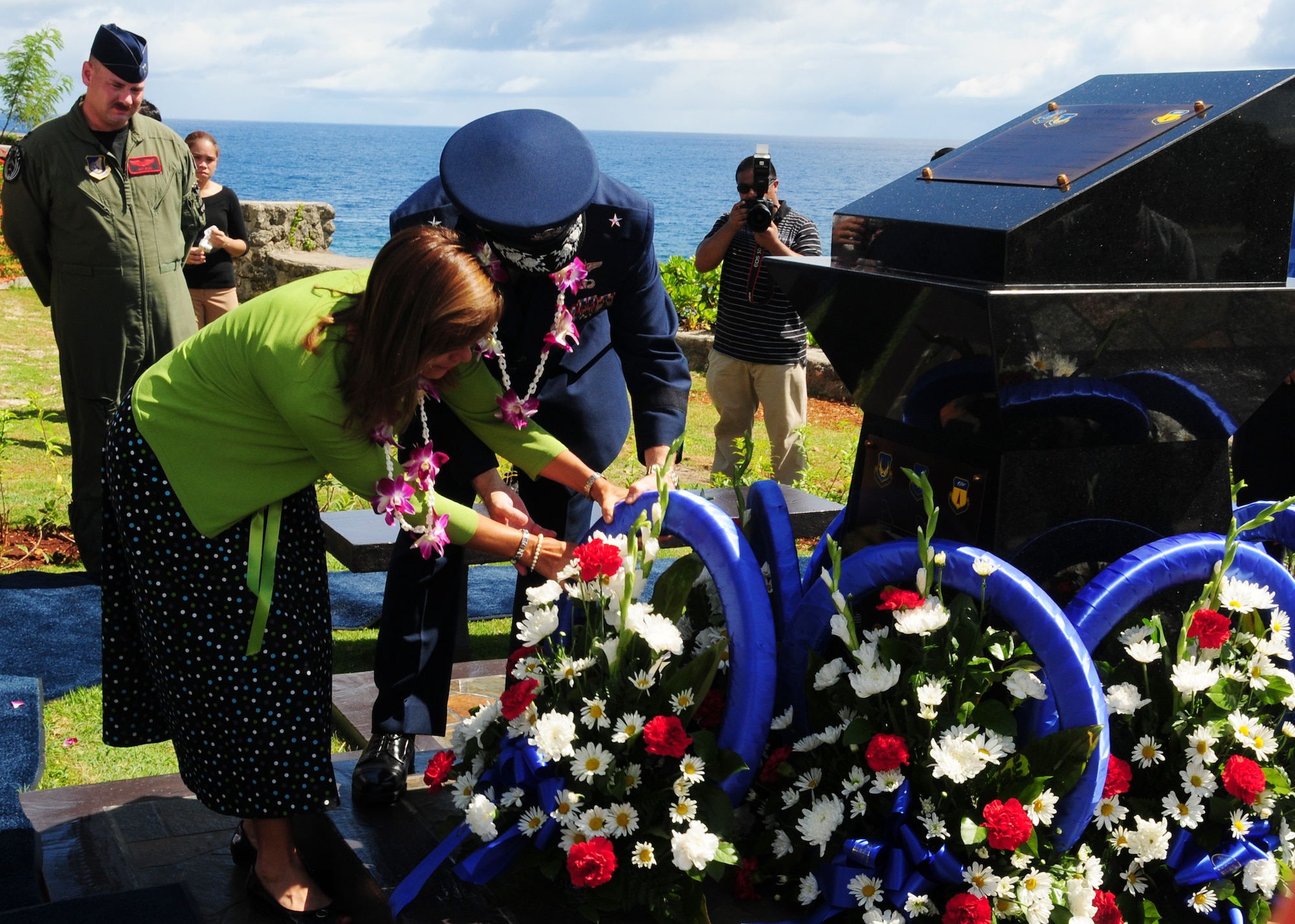 ANDERSEN AIR FORCE BASE, Guam - Brig. Gen. Phil Ruhlman, 36th Wing commander, and wife Lina Ruhlman lay a wreath at the base of the Raider 21 monument at the Governor's Complex at Adelup Point in Hagatna, Guam, July 20. The monument has been built to stand for generations to ensure the crew members of Raider 21 will always be remembered. (U.S. Air Force photo by Senior Airman Nichelle Anderson)