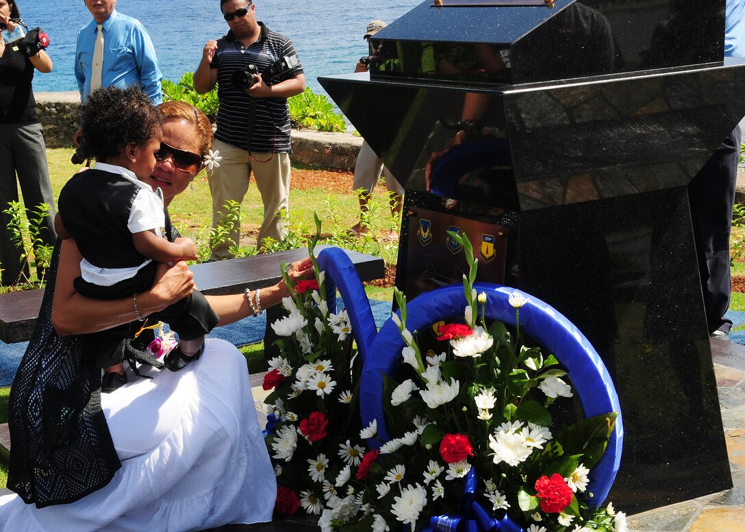 ANDERSEN AIR FORCE BASE, Guam - Ursula Martin, wife of Col. George Martin and their son Guahan Martin lay a wreath at the base of the Raider 21 monument at the Governor's Complex at Adelup Point in Hagatna, Guam, July 20 in remembrance of the husband and father they lost in the Raider 21 crash July 21, 2008. Colonel Martin's family was present at the memorial ceremony as well as many other family and friends of all of the crew members of Raider 21. (U.S. Air Force photo by Senior Airman Nichelle Anderson)