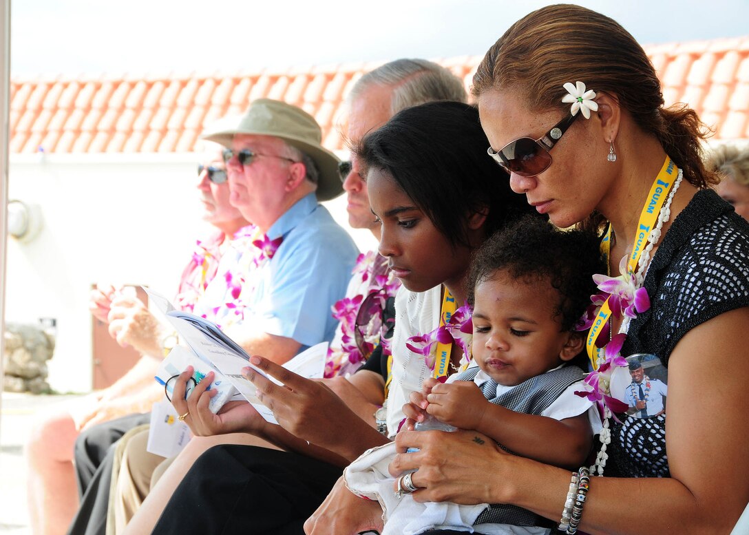ANDERSEN AIR FORCE BASE, Guam - Ursula Martin along with children Guahan and Gemini, family of Col. George Martin, take a moment to reflect on the life of their loving husband and father at the memorial unveiling ceremony at the Governor's Complex at Adelup Point in Hagatna, Guam, July 20. More than 300 family, friends and guest attended the ceremony to remember the six aircrew members of Raider 21 who lost their lives July 21, 2008, about 25 miles off the coast of Guam. (U.S. Air Force photo by Senior Airman Nichelle Anderson)
