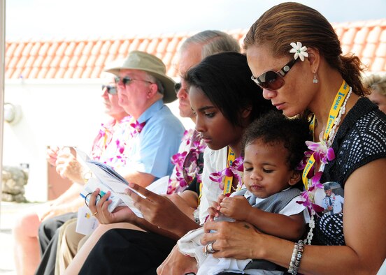 ANDERSEN AIR FORCE BASE, Guam - Ursula Martin along with children Guahan and Gemini, family of Col. George Martin, take a moment to reflect on the life of their loving husband and father at the memorial unveiling ceremony at the Governor's Complex at Adelup Point in Hagatna, Guam, July 20. More than 300 family, friends and guest attended the ceremony to remember the six aircrew members of Raider 21 who lost their lives July 21, 2008, about 25 miles off the coast of Guam. (U.S. Air Force photo/Senior Airman Nichelle Anderson) 