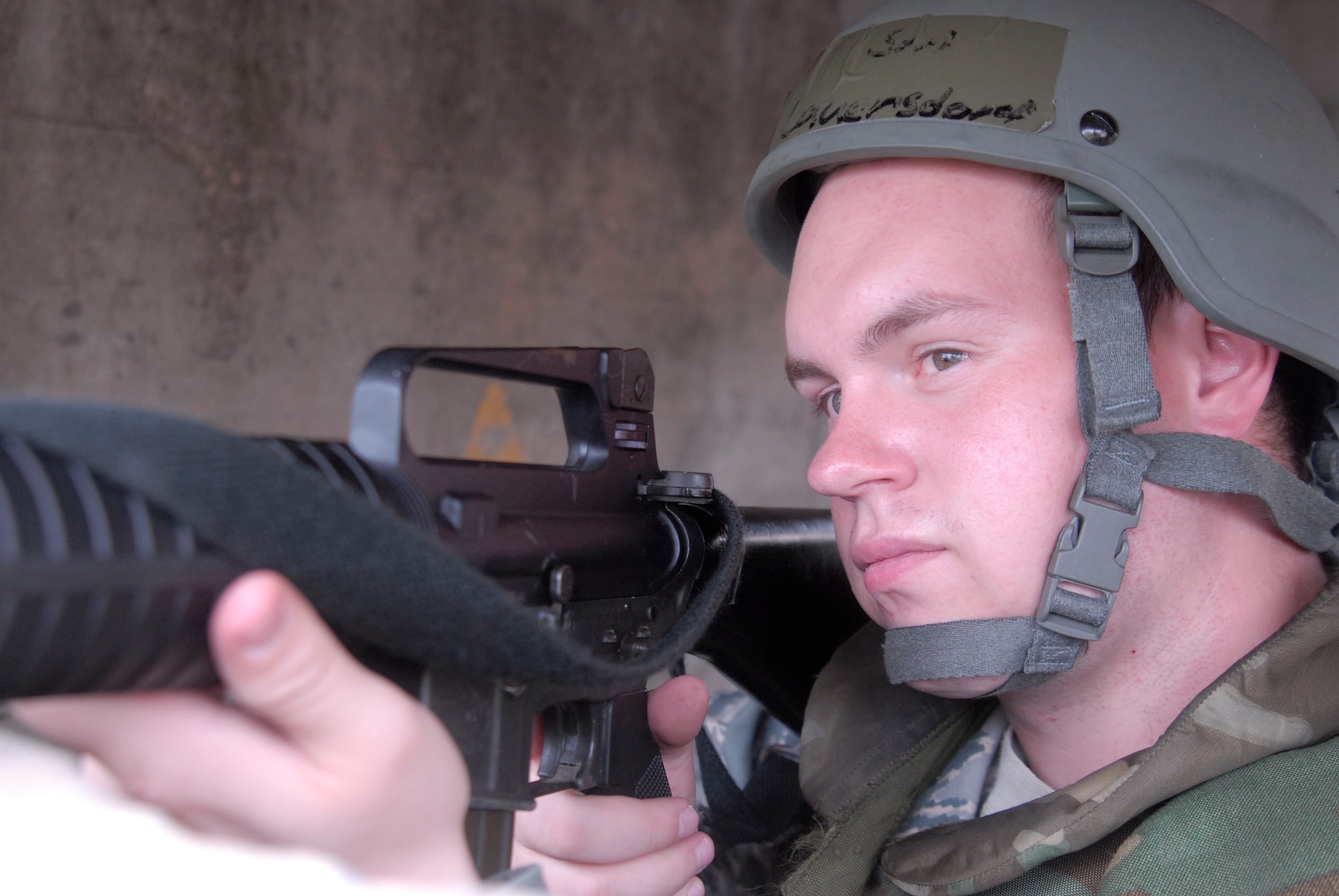 Senior Airman Adam Lauersdorf, 8th Logistics Readiness Squadron inbound cargo, protects the perimeter of the LRS compound from his defensive fighting position July 20, at Kunsan Air Base, Republic of Korea. This Airman is participating in a peninsula wide exercise that exercise's Kunsan's ability to defend the base, accept follow-on forces and take the fight north. (U.S. Air Force photo by Staff Sgt. Darnell T. Cannady)