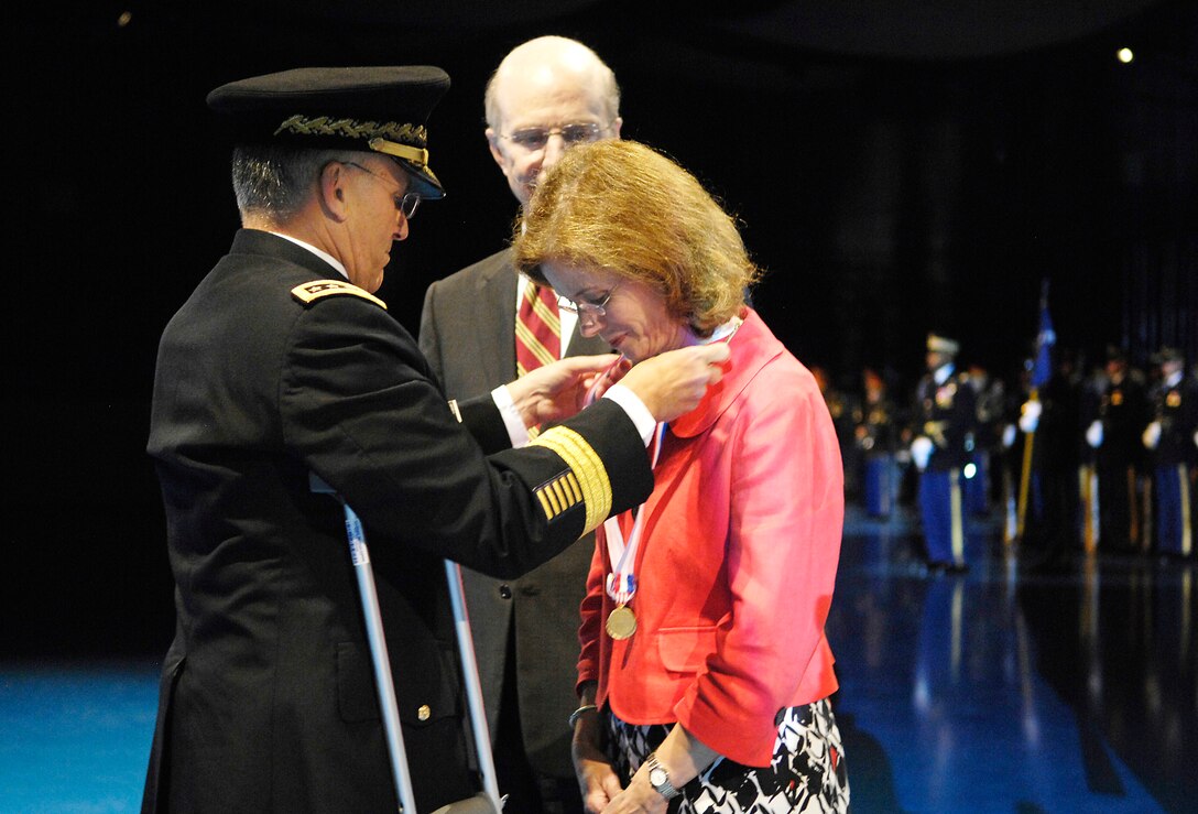 Army Chief of Staff Gen. George Casey bestows honors upon Sheila Geren, wife of Army Secretary Pete Geren, during a farewell ceremony in Geren's honor at Conmy Hall on Fort Myer, Va., July 17, 2009.