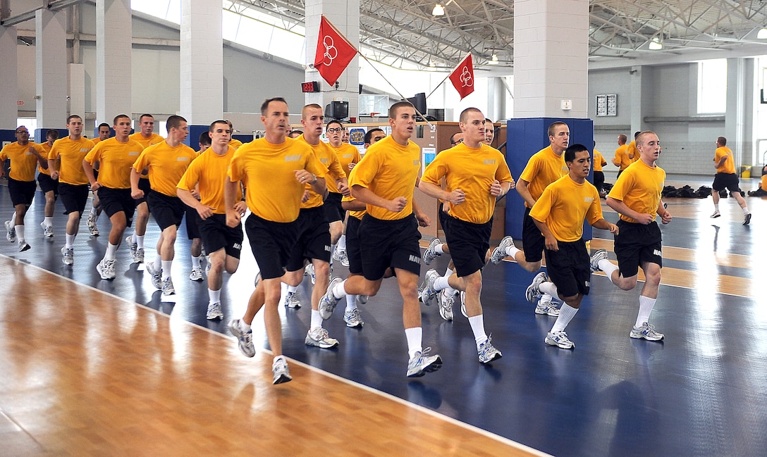 Navy recruits run in formation during a visit by Defense Secretary Robert M. Gates to Great Lakes Naval Training Center, Ill., July 17, 2009.
