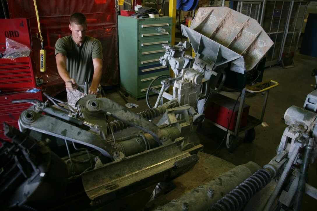 Pfc. Mark Holinsworth, an artillery repair mechanic with Exercise Support Division, works on an M777A2 howitzer July 21.  Holinsworth and his fellow Marines spent a week preparing the weapon for re-deployment to the Combat Center’s training ranges.